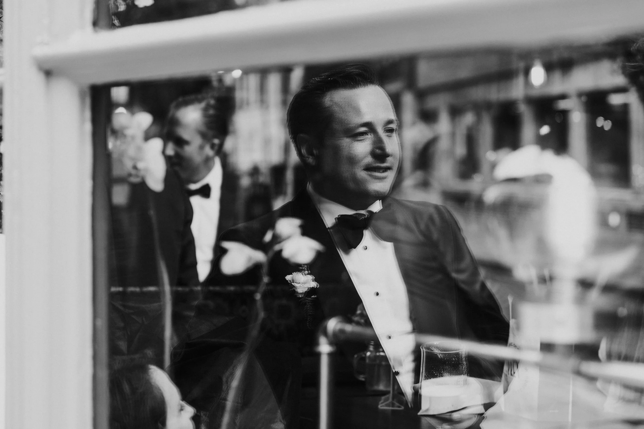 Groom reflection through a pub window at a Old Marylebone Town Hall Wedding