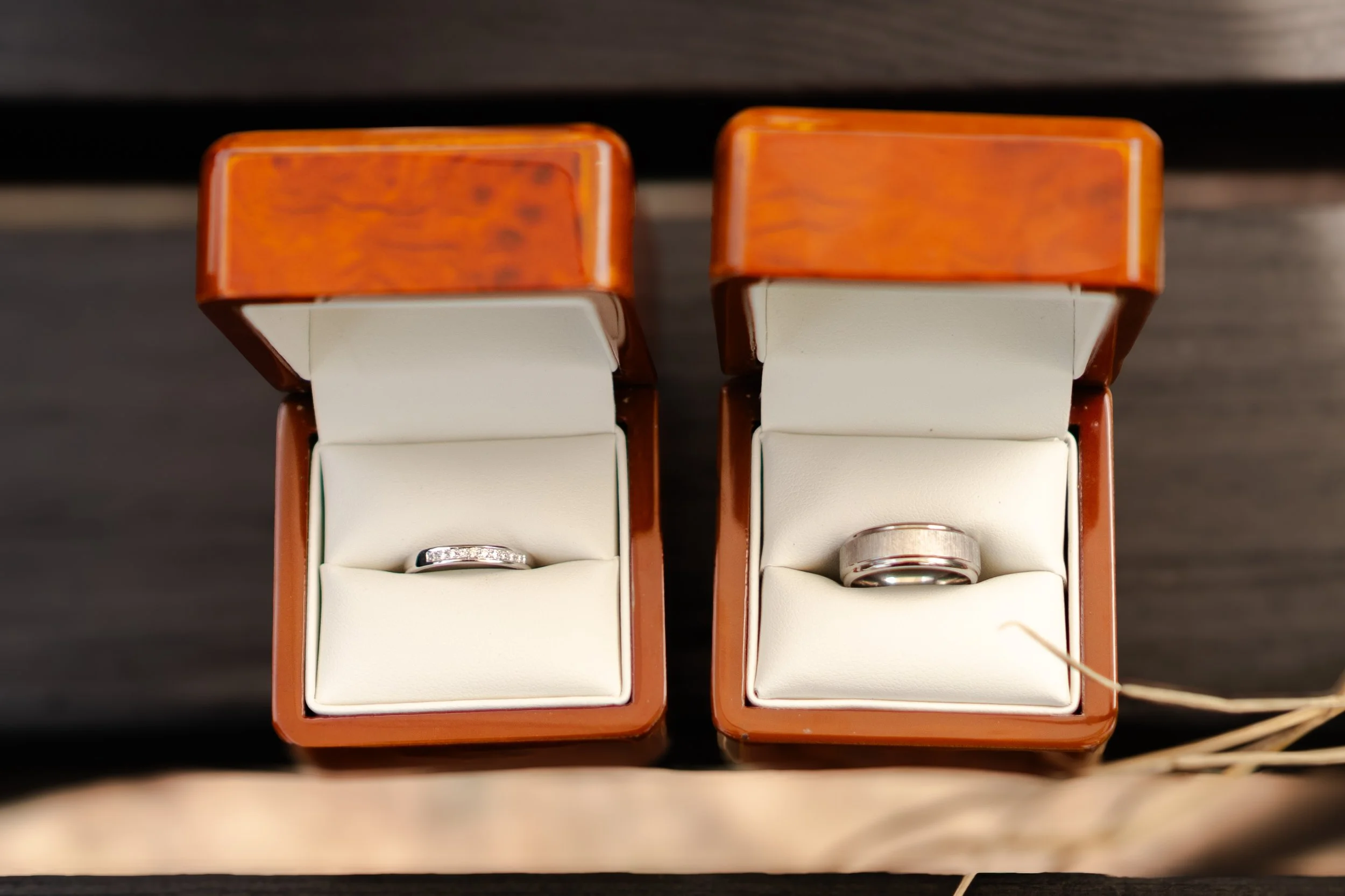 wedding rings in their boxes open to display the rings at a rhyse farm wedding
