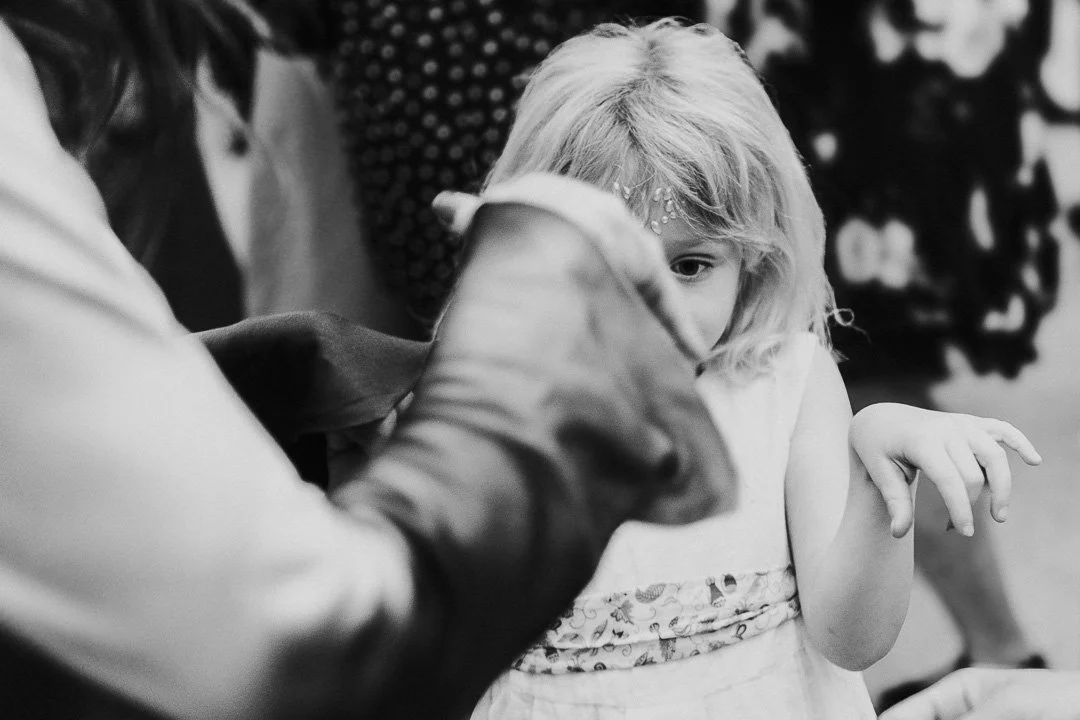 A young guest copying an adult guest hands movements on the dancefloor at a Hampton Court House Wedding.
