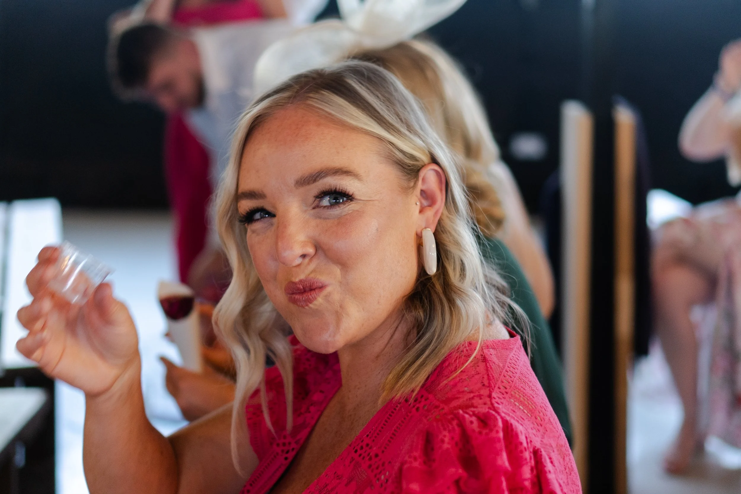 Wedding guest smiling after drinking a shot at the ceremony at a rhyse farm wedding