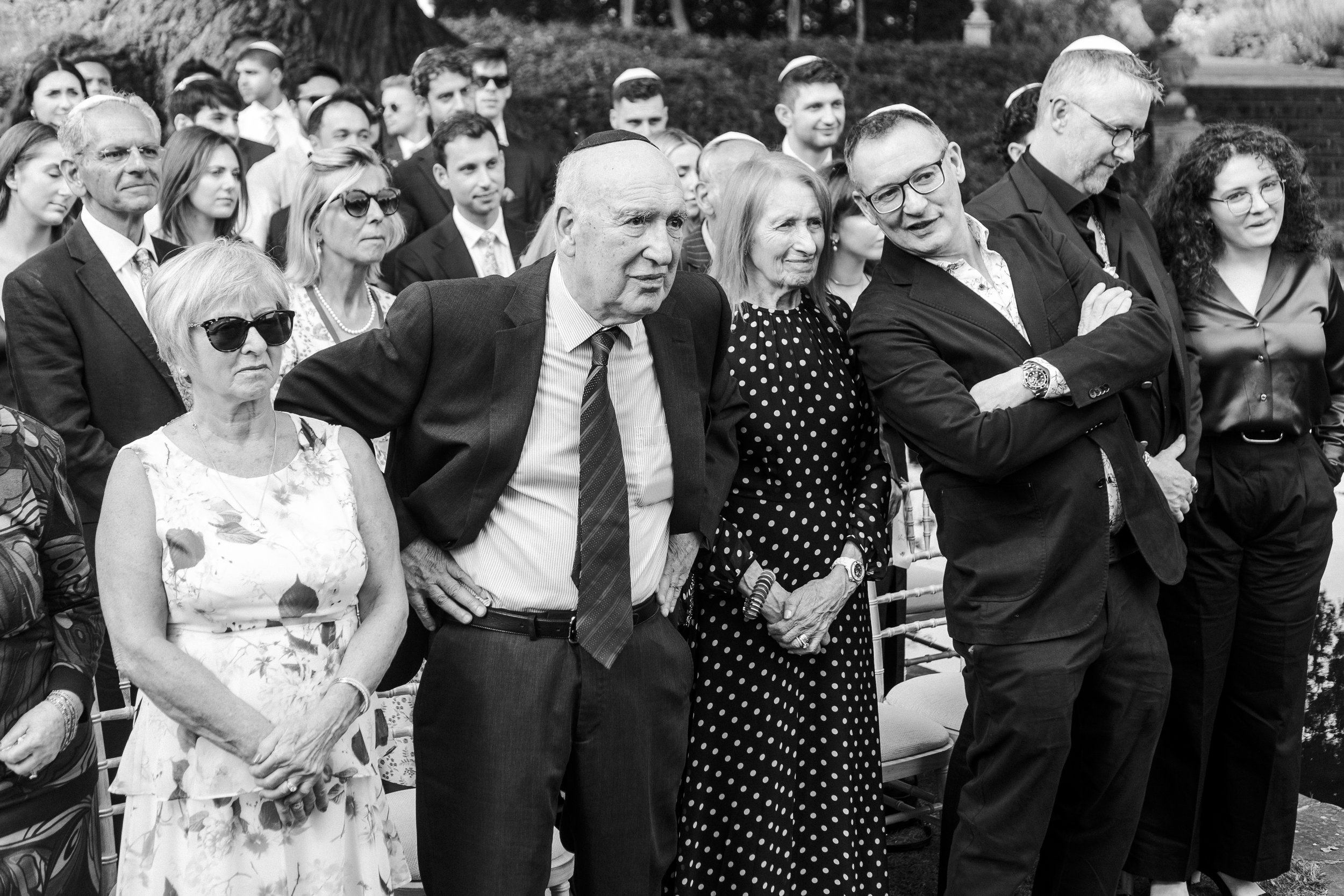 Guest standing before the ceremony A image of the lawn leading towards The Temple at a Micklefield Hall Wedding