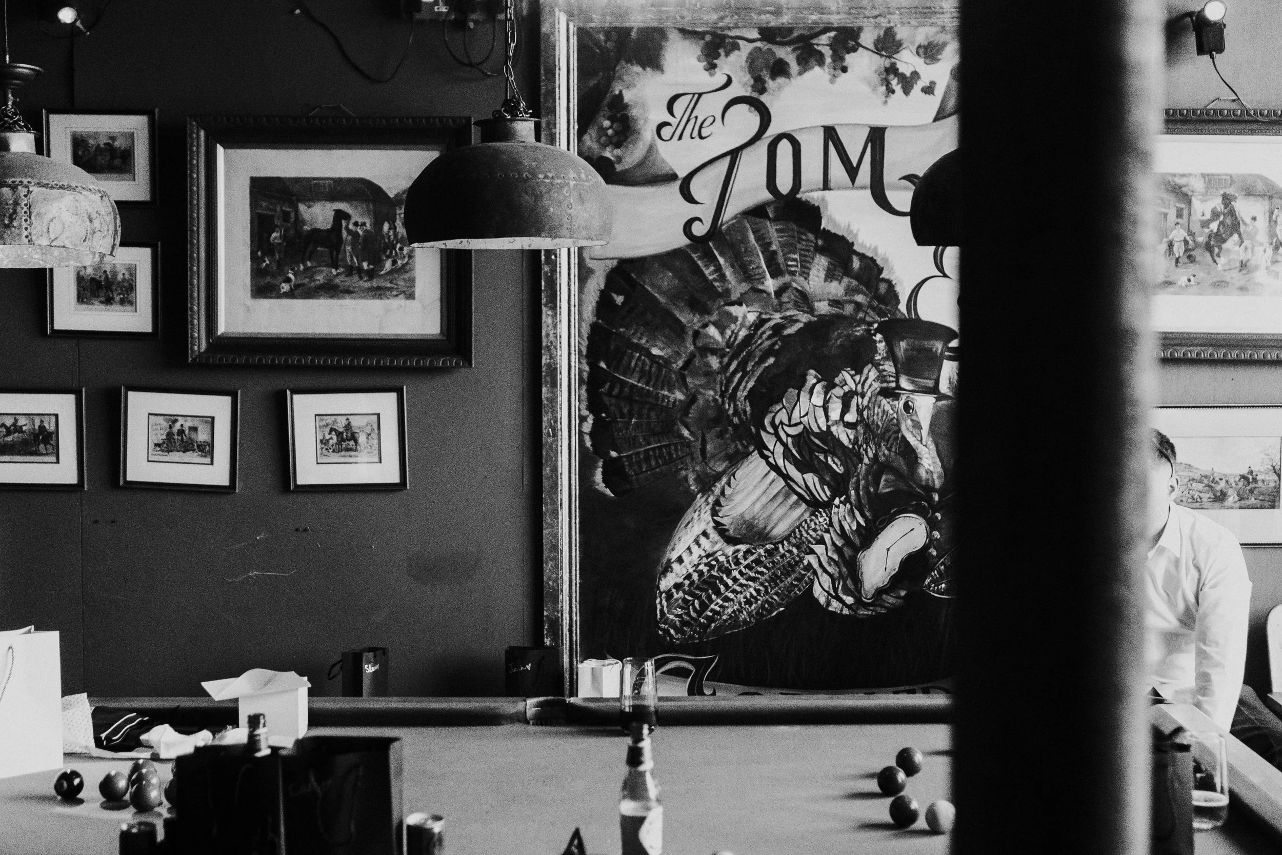 Large turkey poster framed hanging on the Barn Wall, with a pool table in front at a rhyse farm wedding
