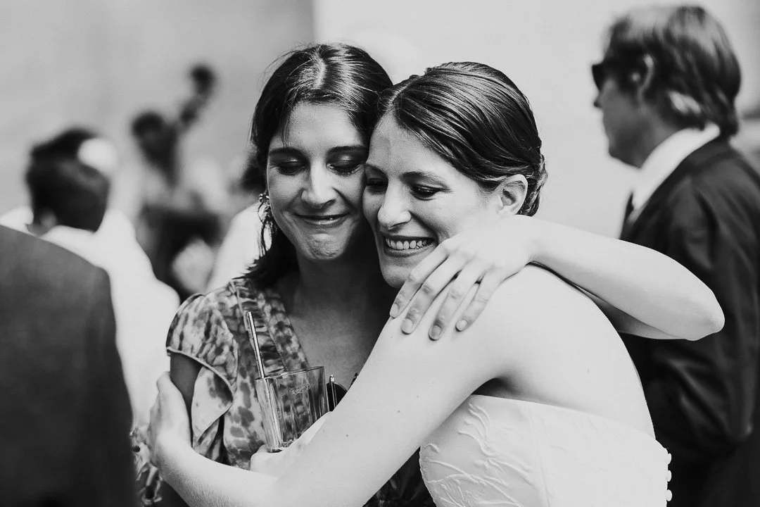 Bride hugging a guest at a Hampton Court House Wedding.