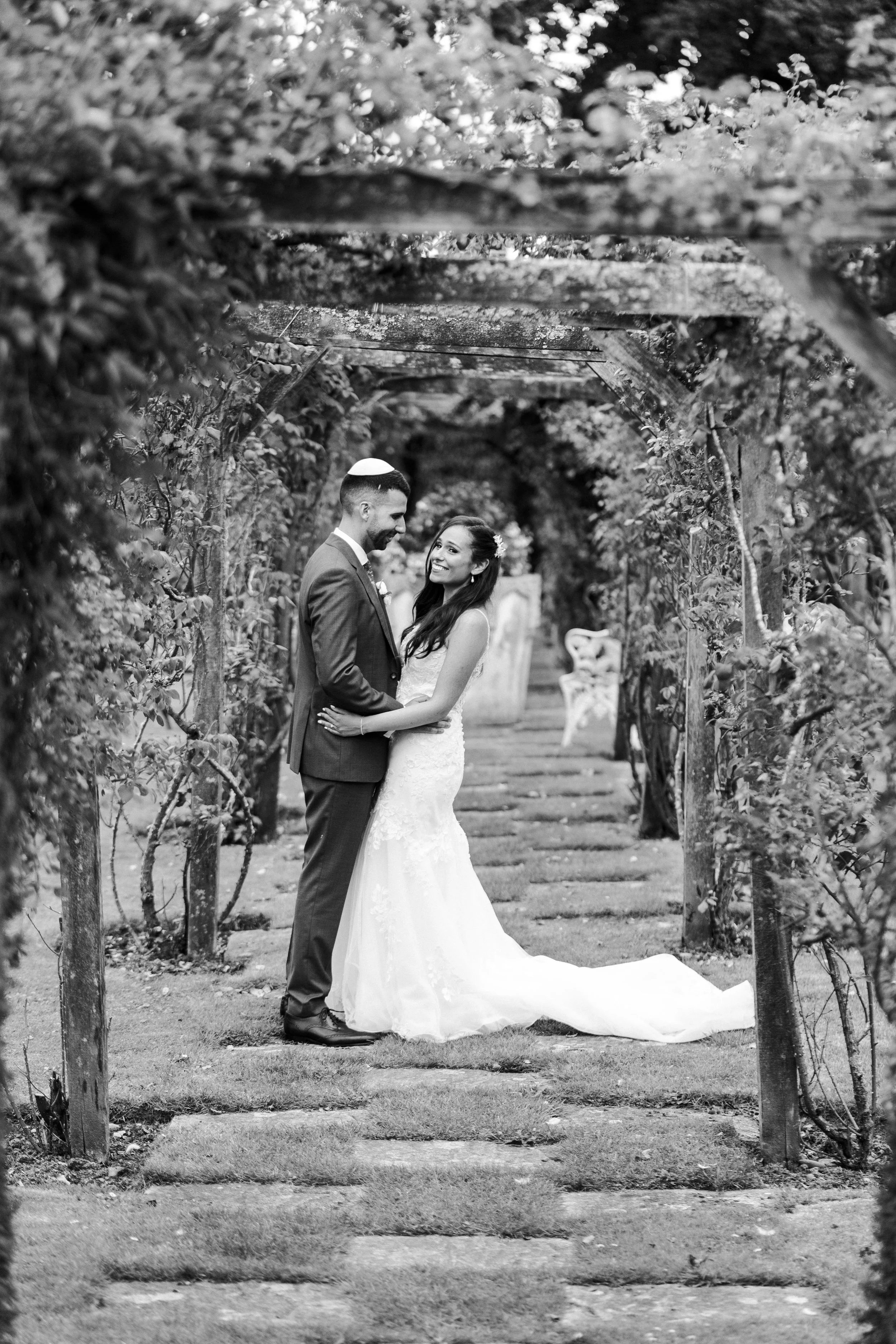 Wedding couple posing in the orchard with both smiling at a Micklefield Hall Wedding