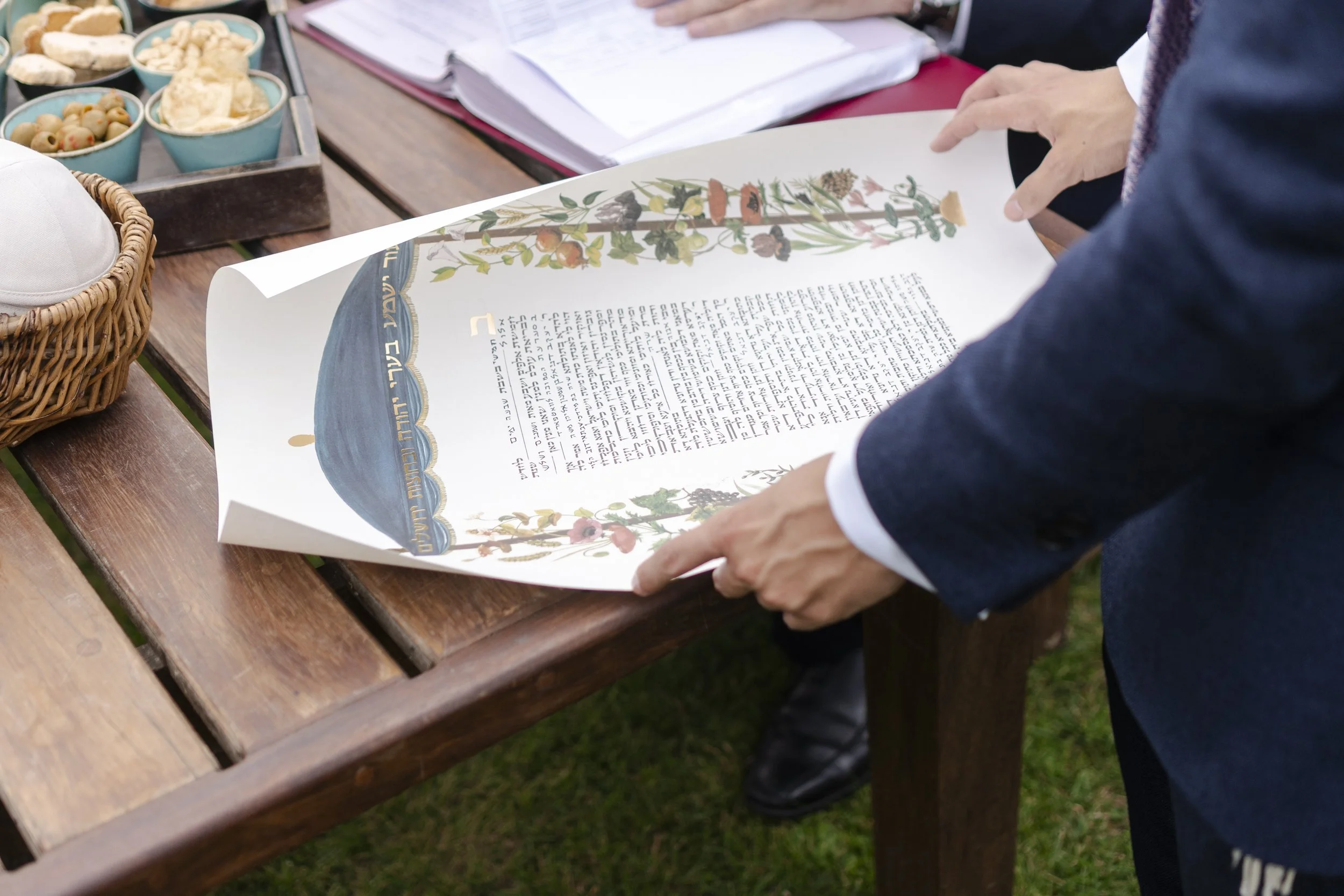 A Rabbi opening a Ketubah on the table at a Micklefield Hall Wedding