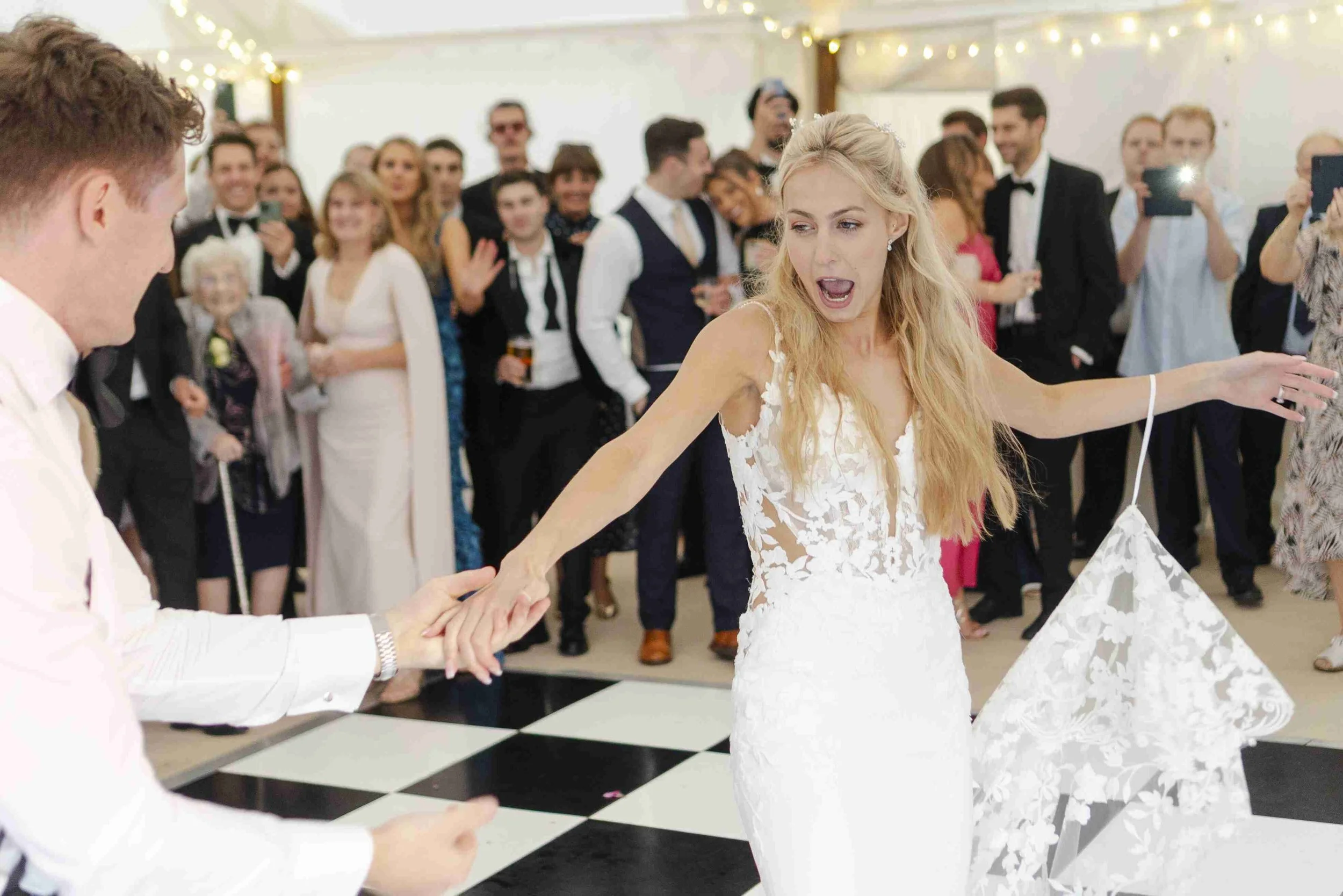 Bride & Groom on the dance floor hand in hand dancing at the Halfmoon Farm Wedding in Rutland