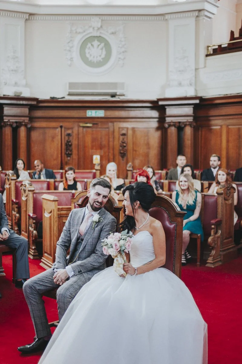 Bride & Groom laughing in The Council Chambers at Islington Town Hall Wedding Venue