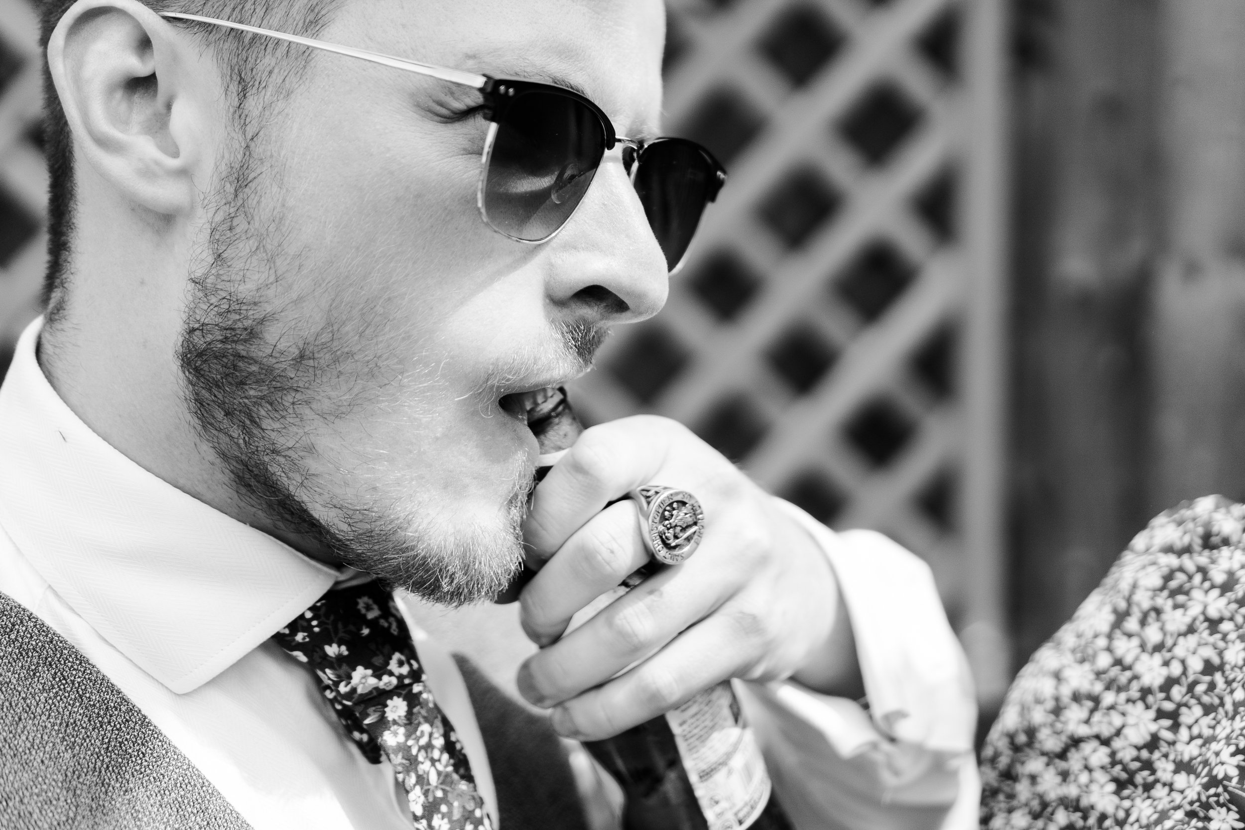 Wedding guest opening a bottle of lager with his teeth at a rhyse farm wedding