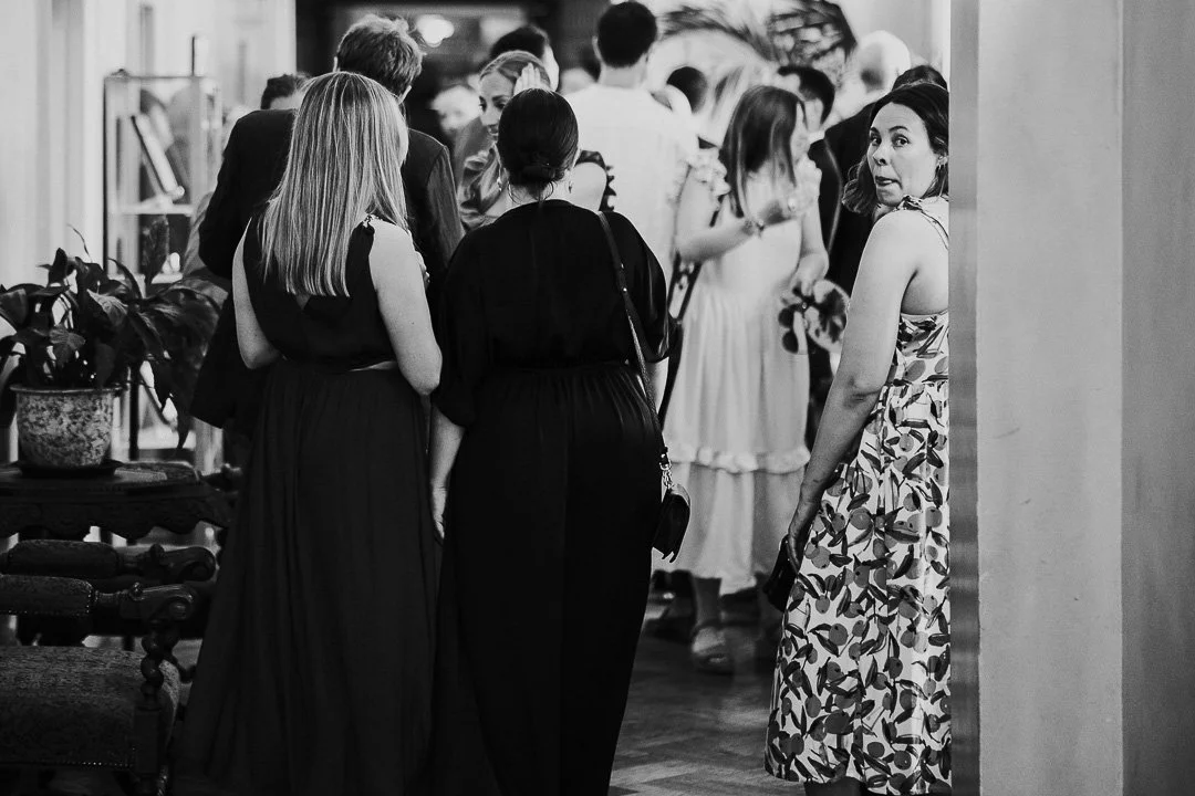 Guest turning around and looking at the camera in the ceremony room  at a Hampton Court House Wedding