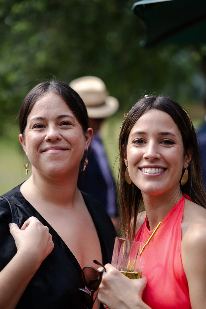 Two guests both smiling while looking at the camera at a Hampton Court House Wedding.