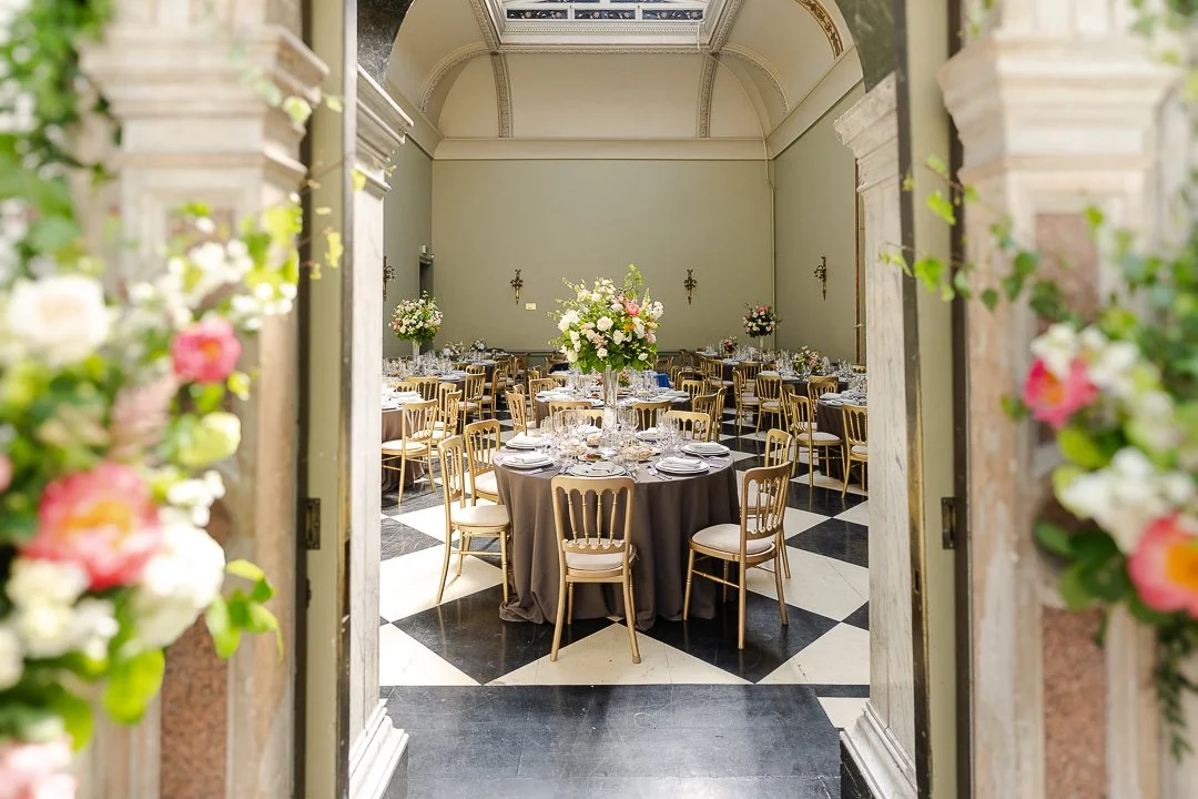A wide view from the entrance of the Reception room decorated for the Wedding Breakfast at a Hampton Court House Wedding.