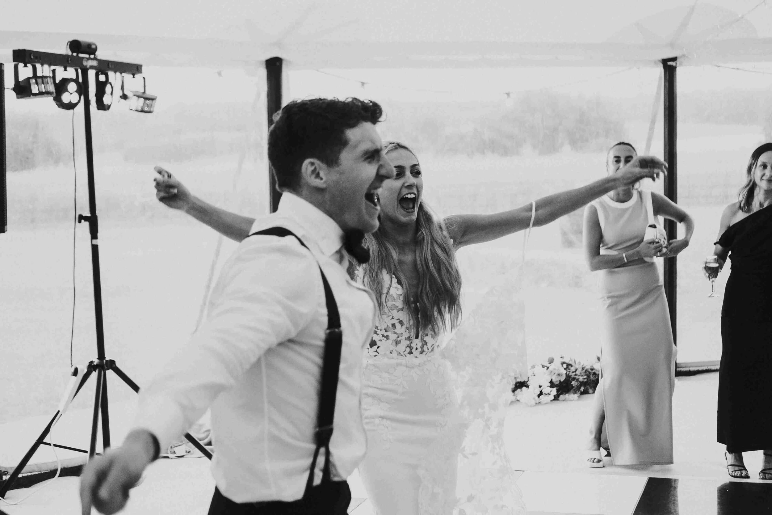 Couple on the dancefloor shouting happily to the guests at the Halfmoon Farm Wedding in Rutland