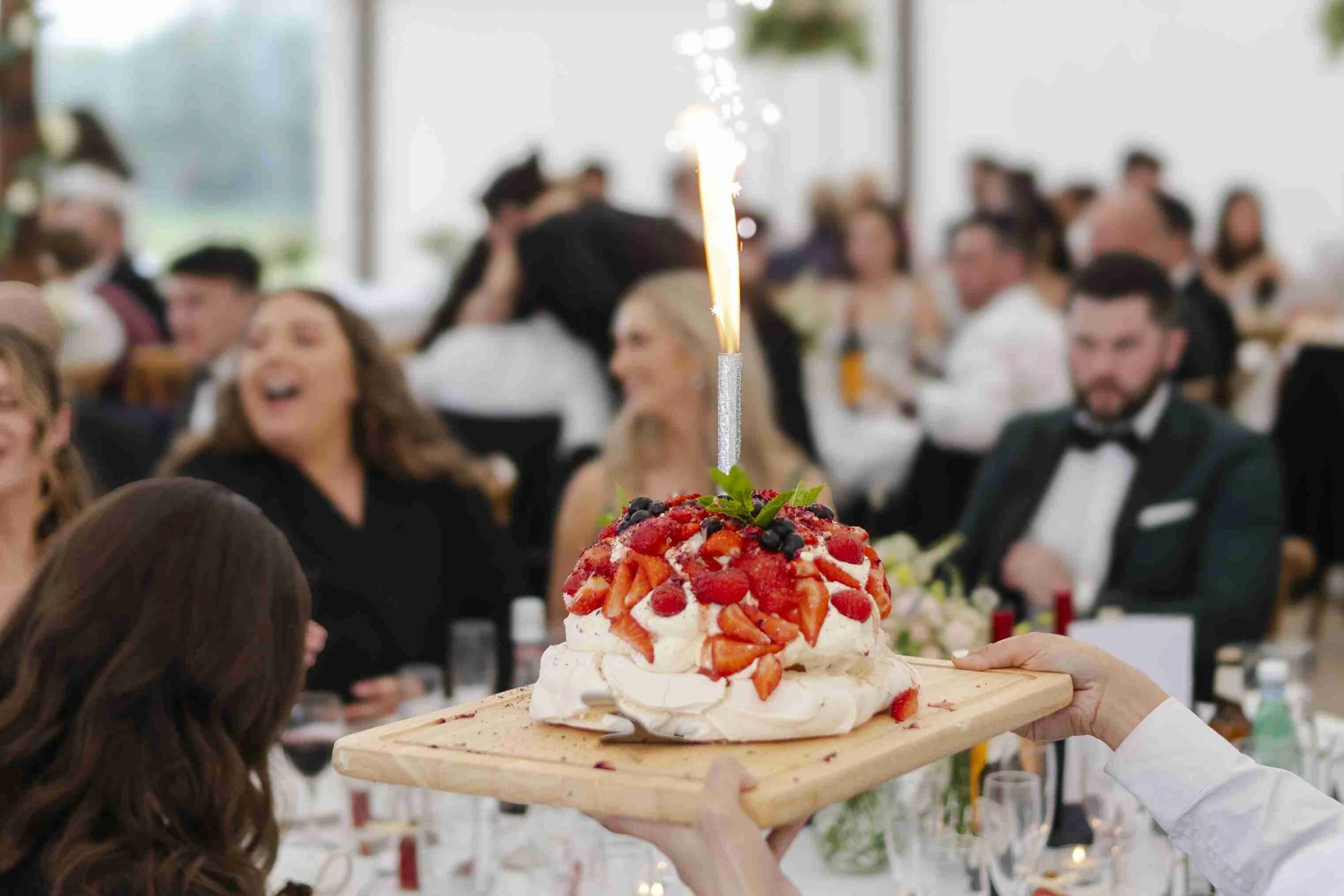 Wedding Cake with a sparkler in the Wedding Reception Marquee at the Halfmoon Farm Wedding in Rutland