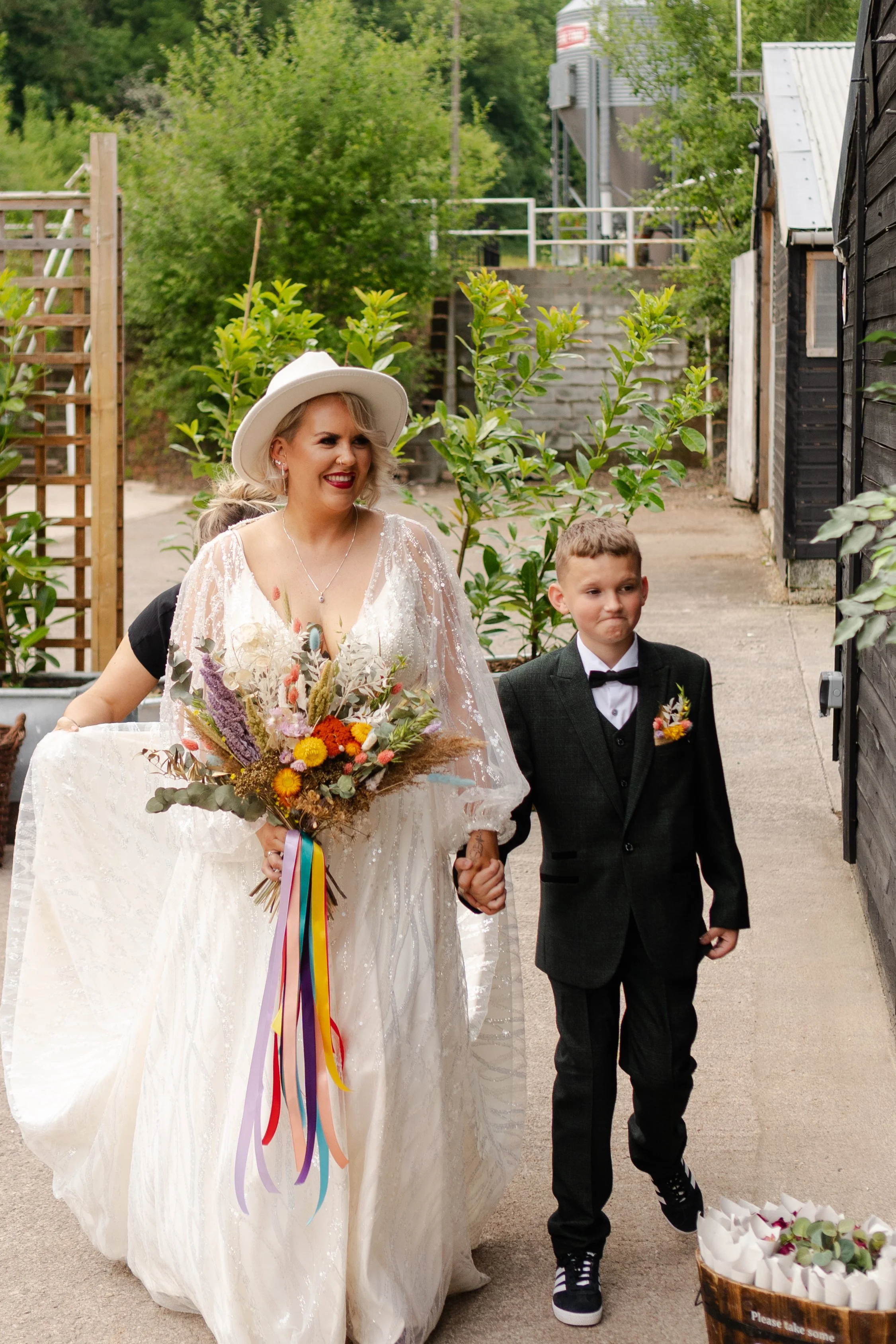 Bride and Pageboy outside the Ceremony Barn just before walking into the ceremony at a rhyse farm wedding
