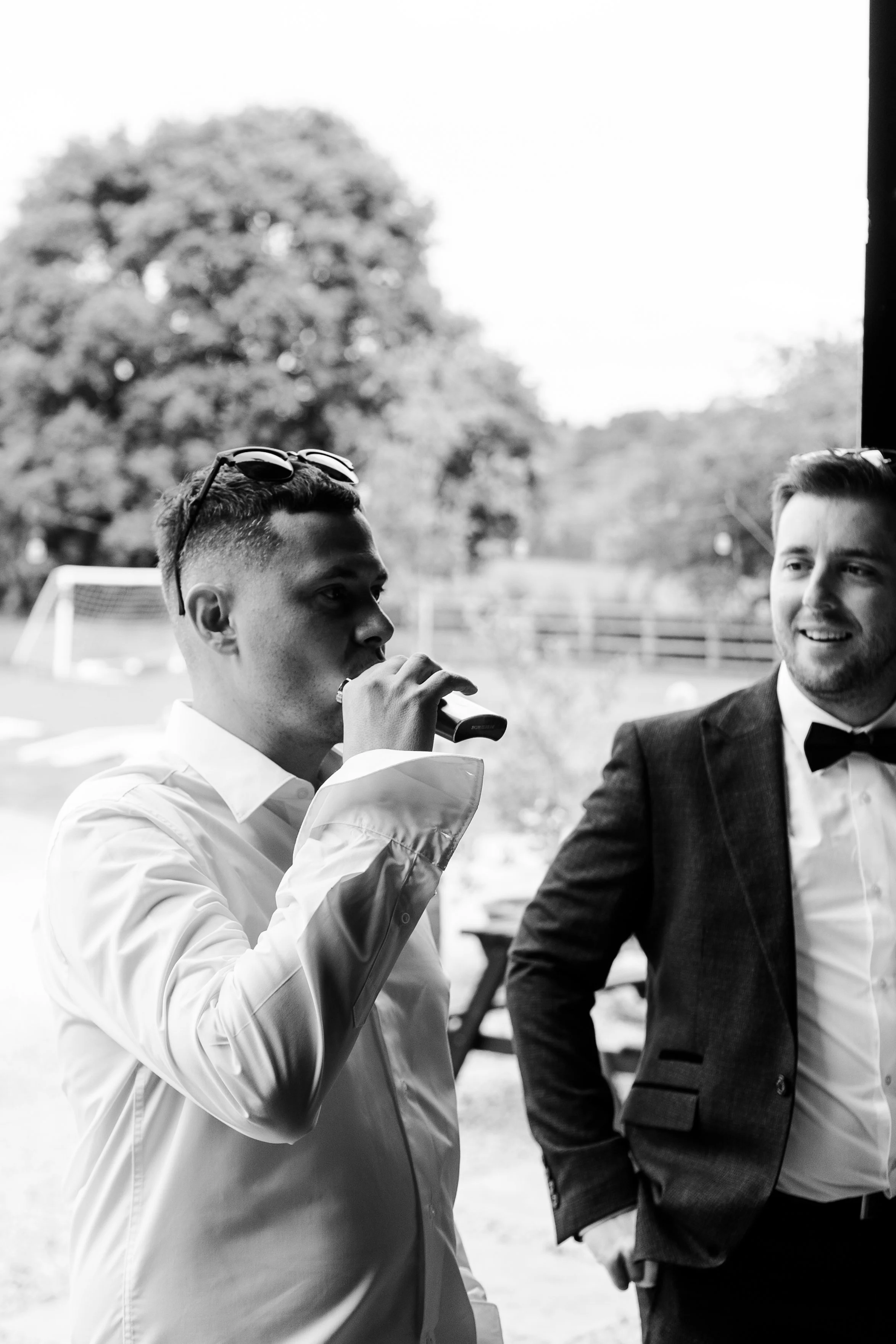 Groom taking a sip from a hip flask at a rhyse farm wedding