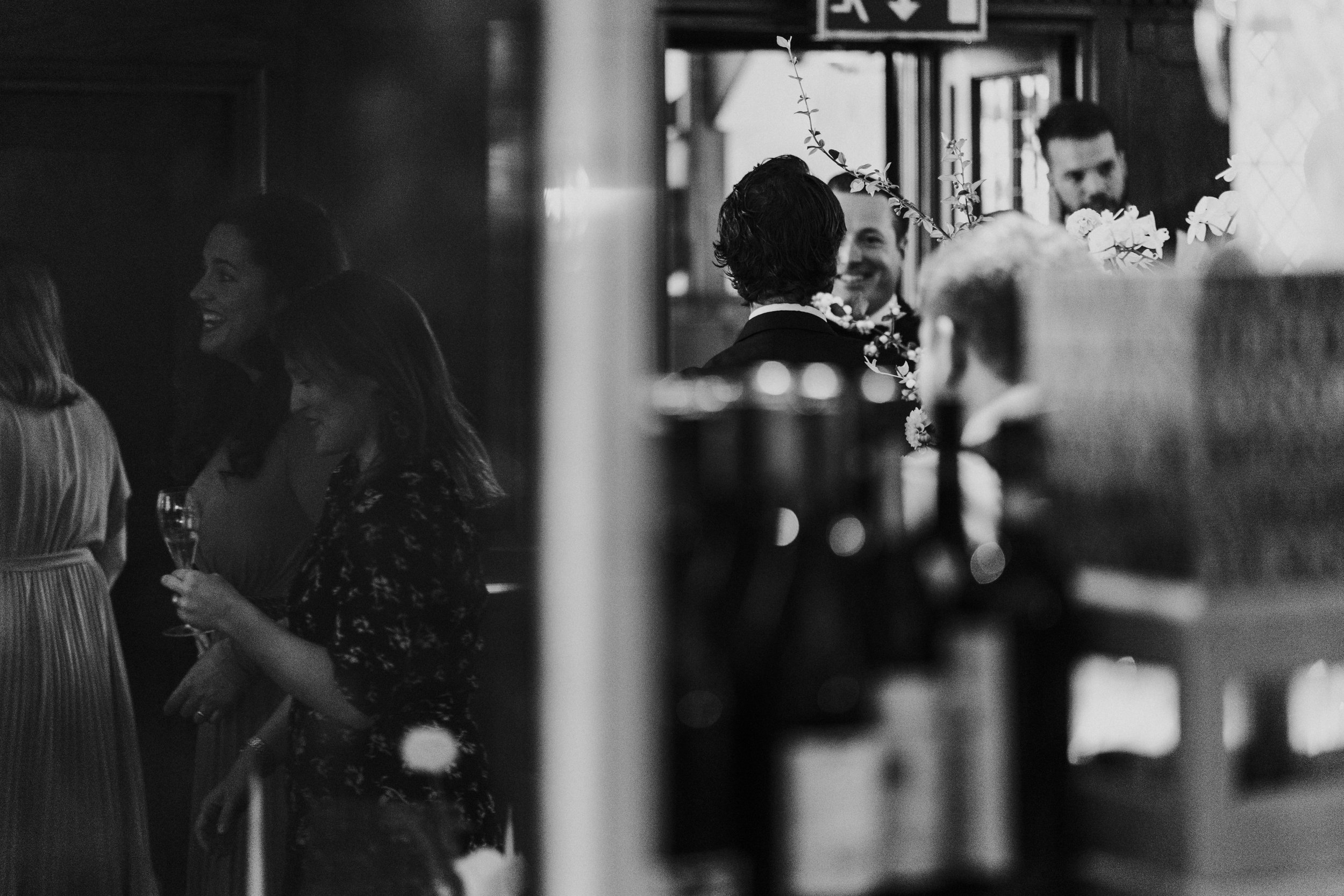 Wedding guests mingling inside The Ivy Restaurant at a Old Marylebone Town Hall Wedding.