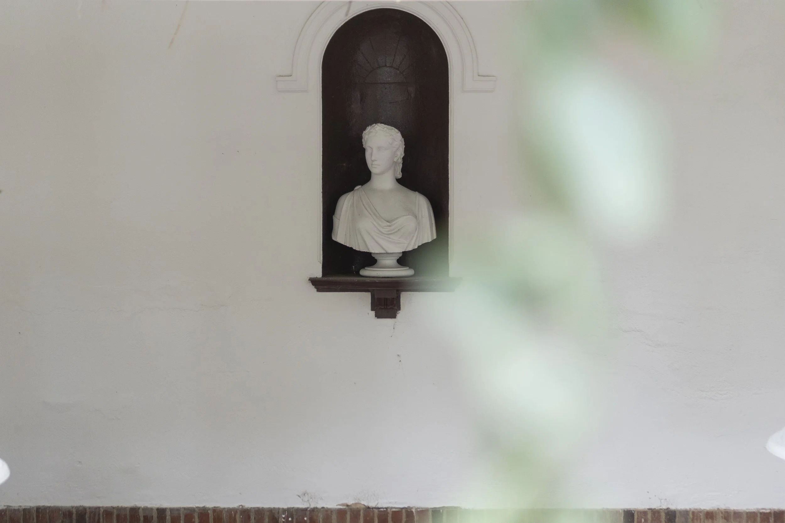 A bust displayed in a wall in The Temple at a Micklefield Hall Wedding