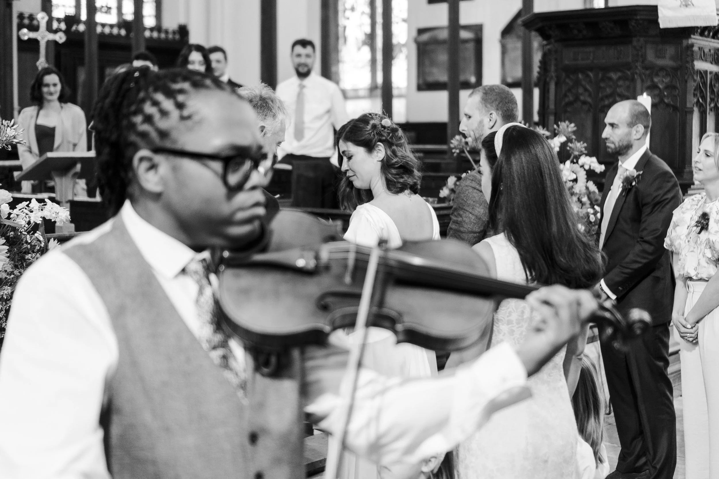 Volinlist playing while the Wedding couple standing at the front of the altar at St Michael's Church at a Highgate, London Wedding