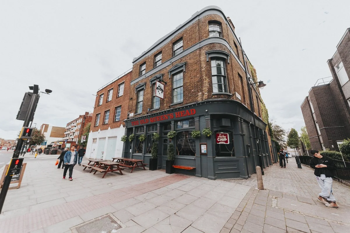 Side view of The Old Queens Head Pub on Essex Road, Islington, showing the full frontal and side of the pub.