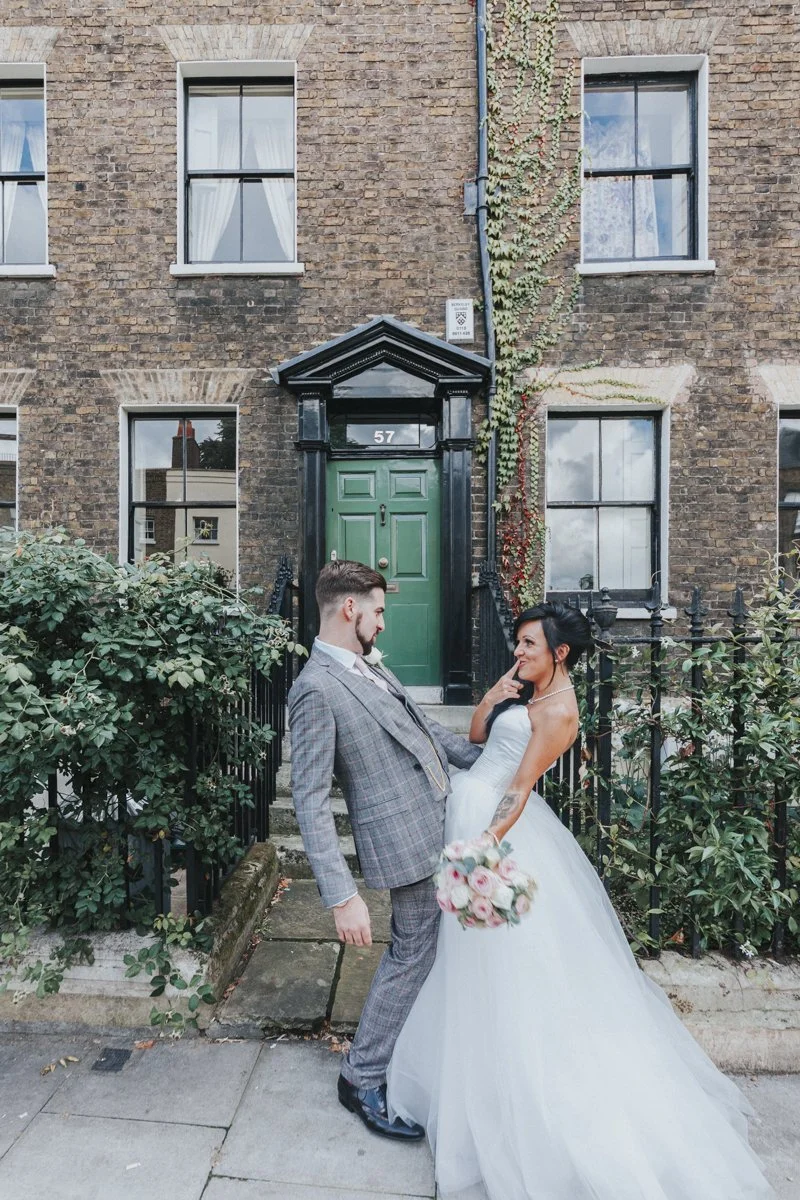 Bride & Groom posing funnily outside an Iconic Islington Townhouse near Islington Town Hall Wedding Venue