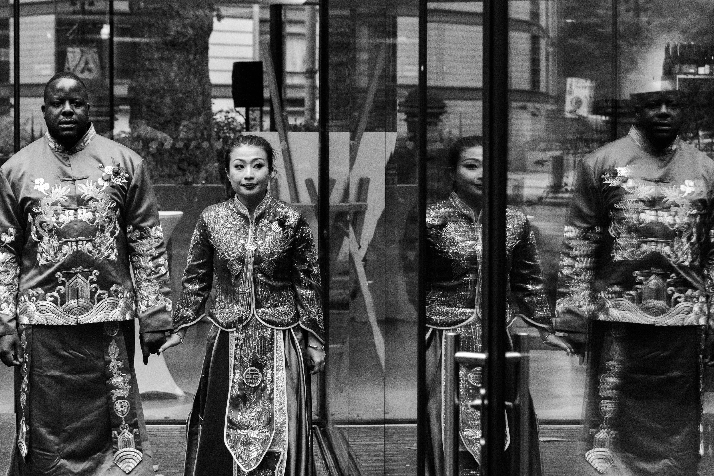 Black & White portrait of a London Wedding Couple with their reflection in a glass window