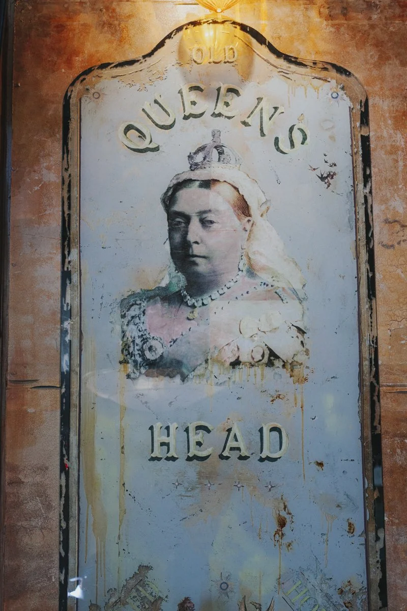 A old framed image of Queen Victoria with the words Queens Head at the iconic The Old Queens Head pub, Essex Road, Islington for a London Wedding