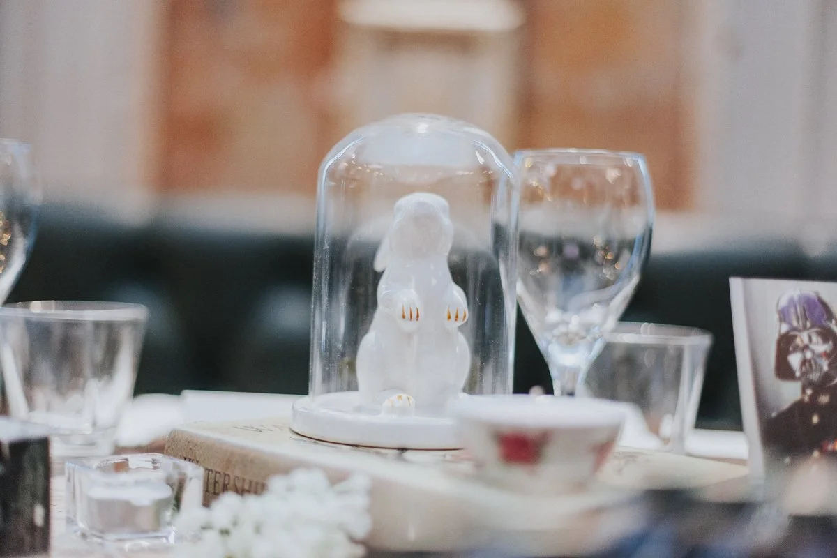 A porcelain rabbit under a glass dome on the Wedding Top Table at the iconic The Old Queens Head pub, Essex Road, Islington for a London Wedding