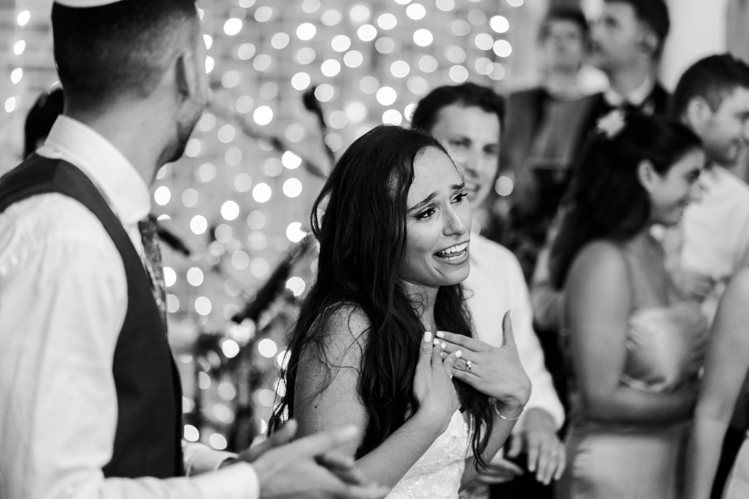 Bride singing with her hand on her heart at a wedding reception at a Micklefield Hall Wedding