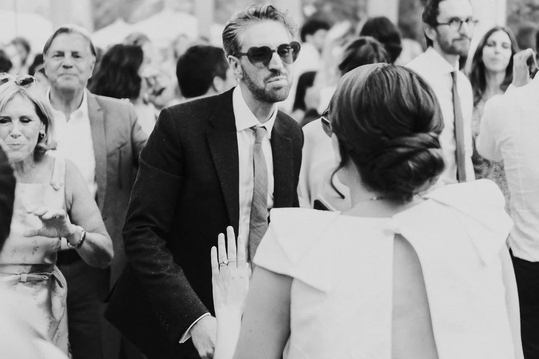 Bride & Groom in the middle of the dancefloor both wearing heart-shaped sunglasses and facing each other dancing at a Hampton Court House Wedding.