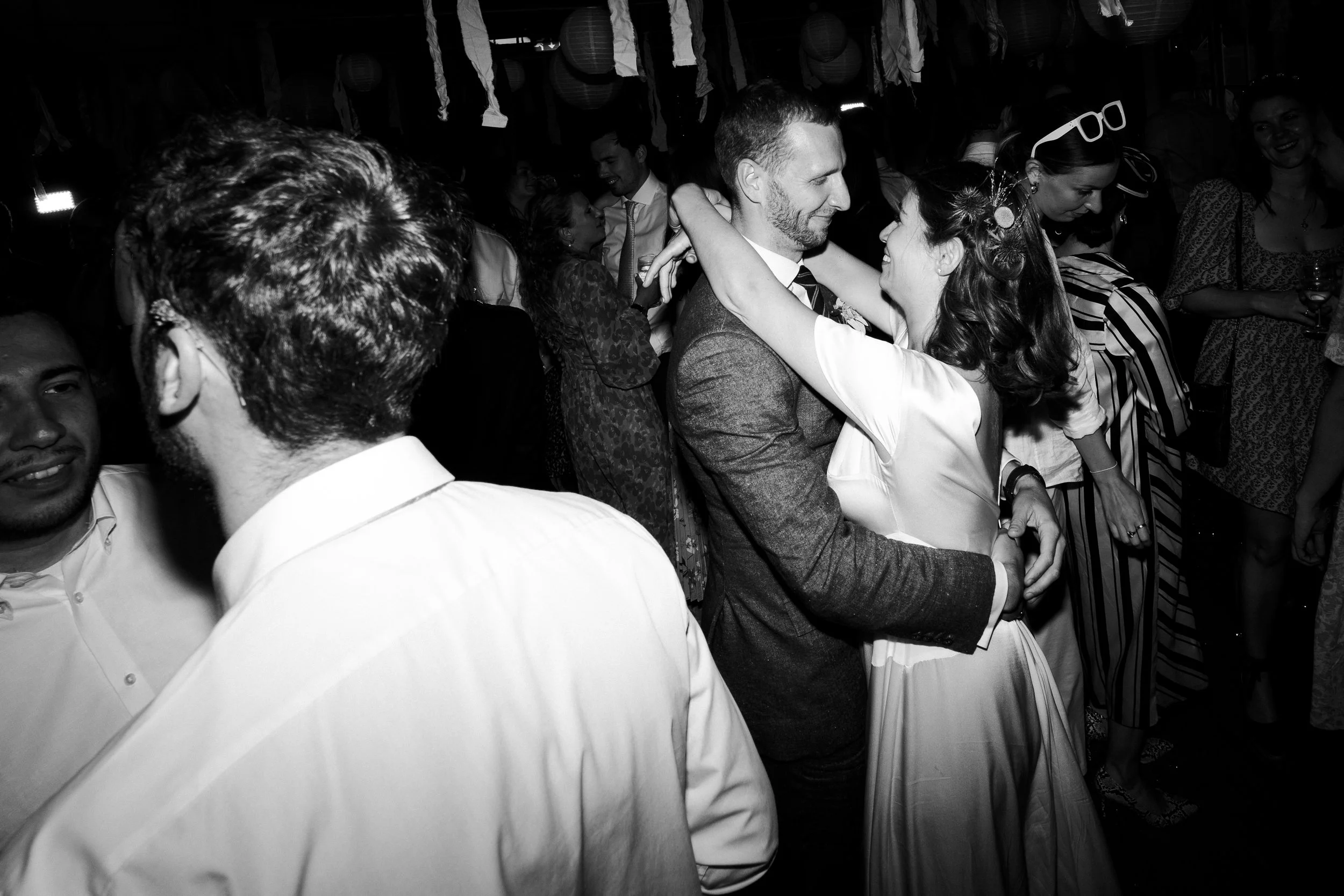 Wedding couple dancing with the bride arms around the groom and both smiling at each other at a Highgate, London Wedding.