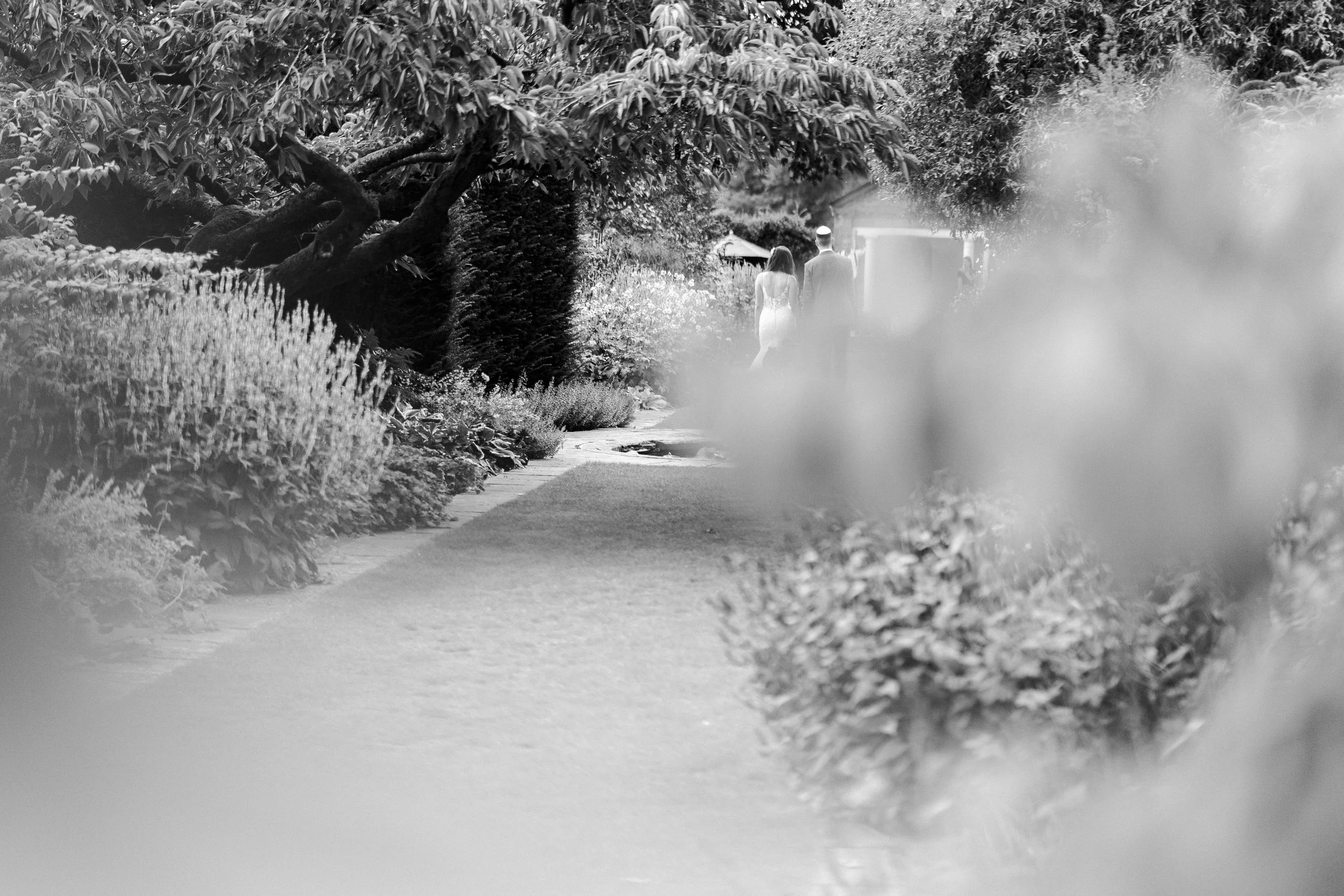 Wedding couple walking towards The Temple at a Micklefield Hall Wedding