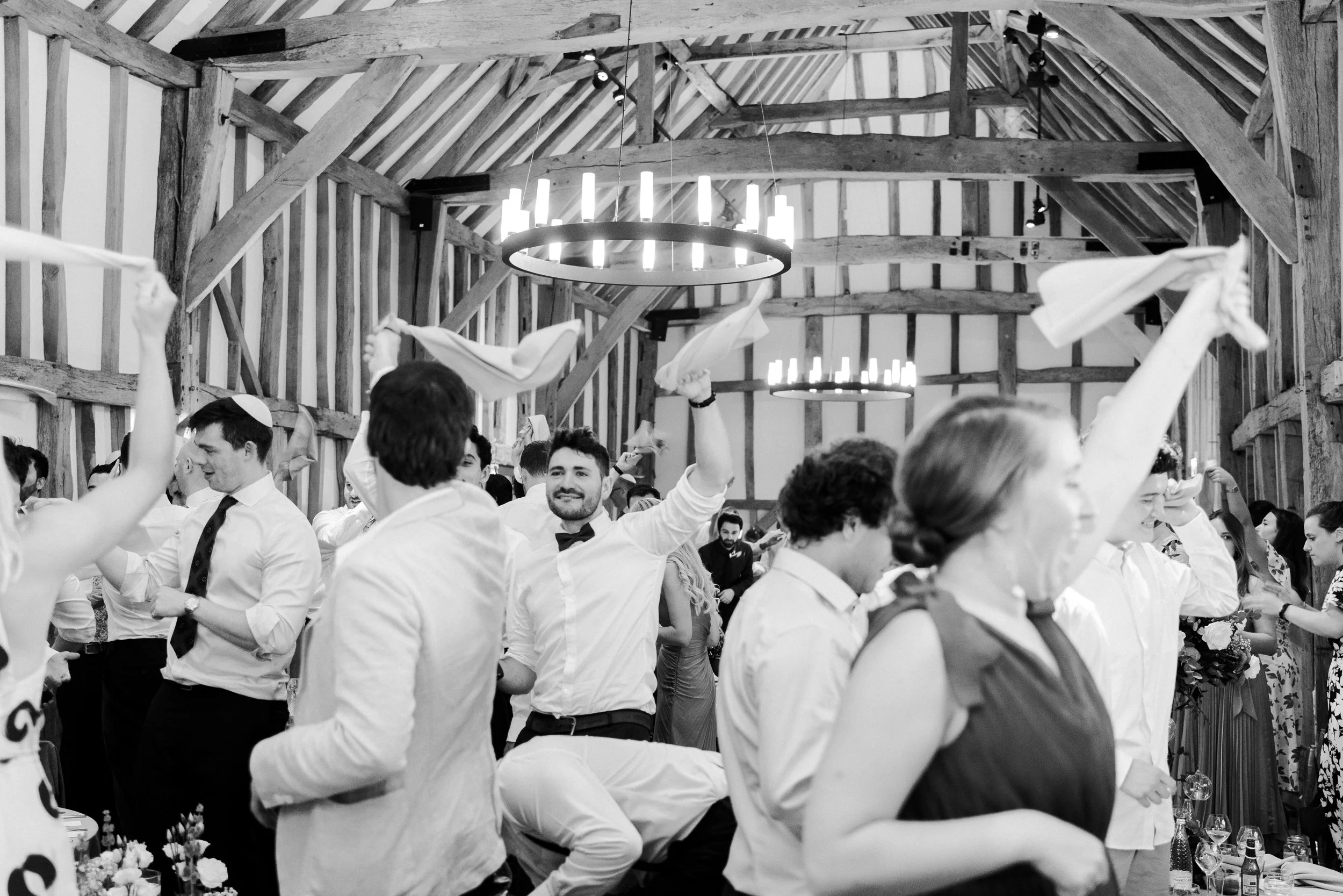 Wedding guests with handkerchiefs waving at the wedding reception at a Micklefield Hall Wedding