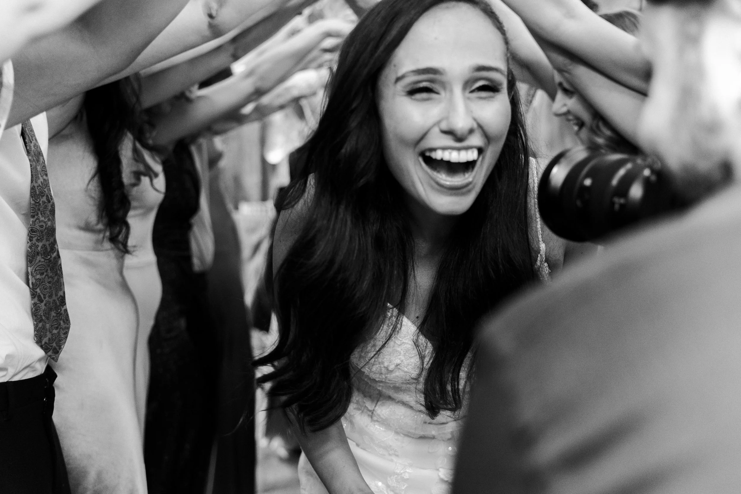 Bride walking through a human tunnel at a Micklefield Hall Wedding