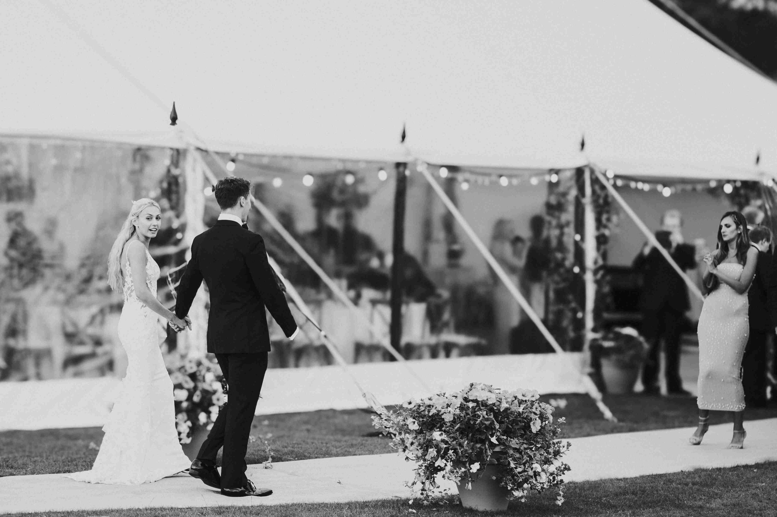 Couple walking into the wedding reception marquee at the Halfmoon Farm Wedding in Rutland