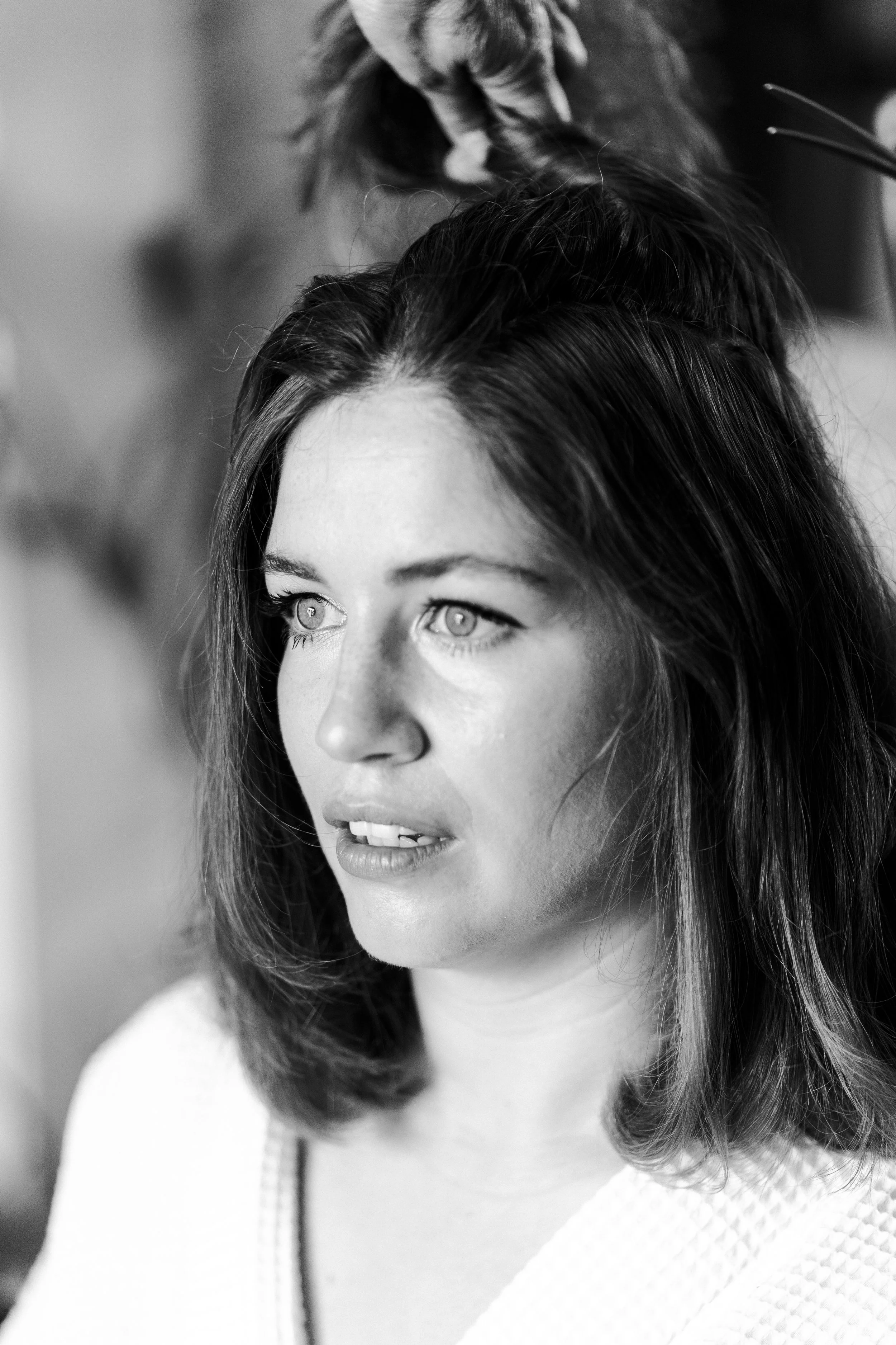 Bride staring in front while her hair is clipped up at a Highgate, London Wedding