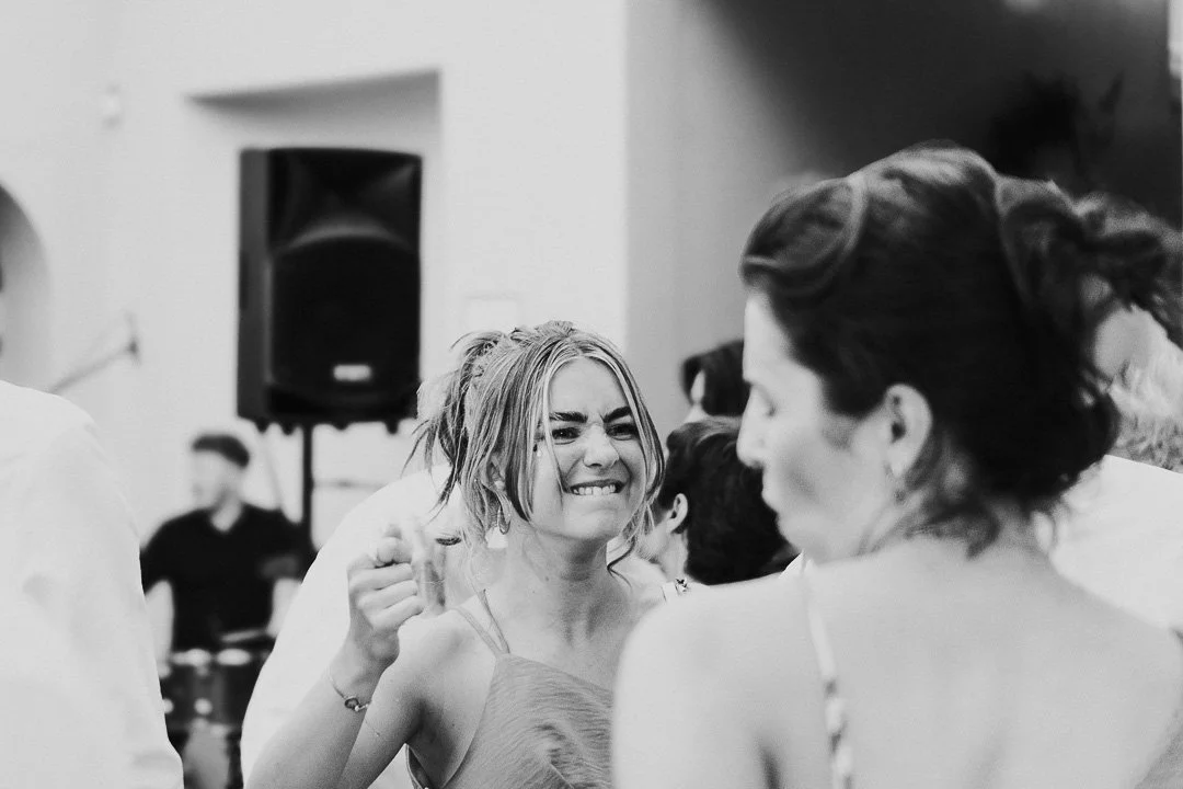 Two guests facing each other and dancing on the dance floor  at Hampton Court House at a Surrey Wedding.