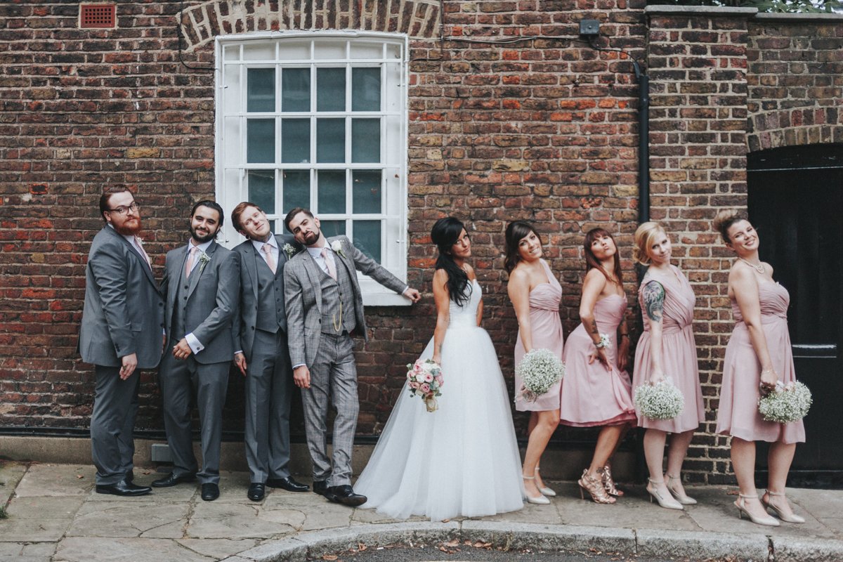 Bridal Party poaing against a wall near Islington Town Hall Wedding Venue