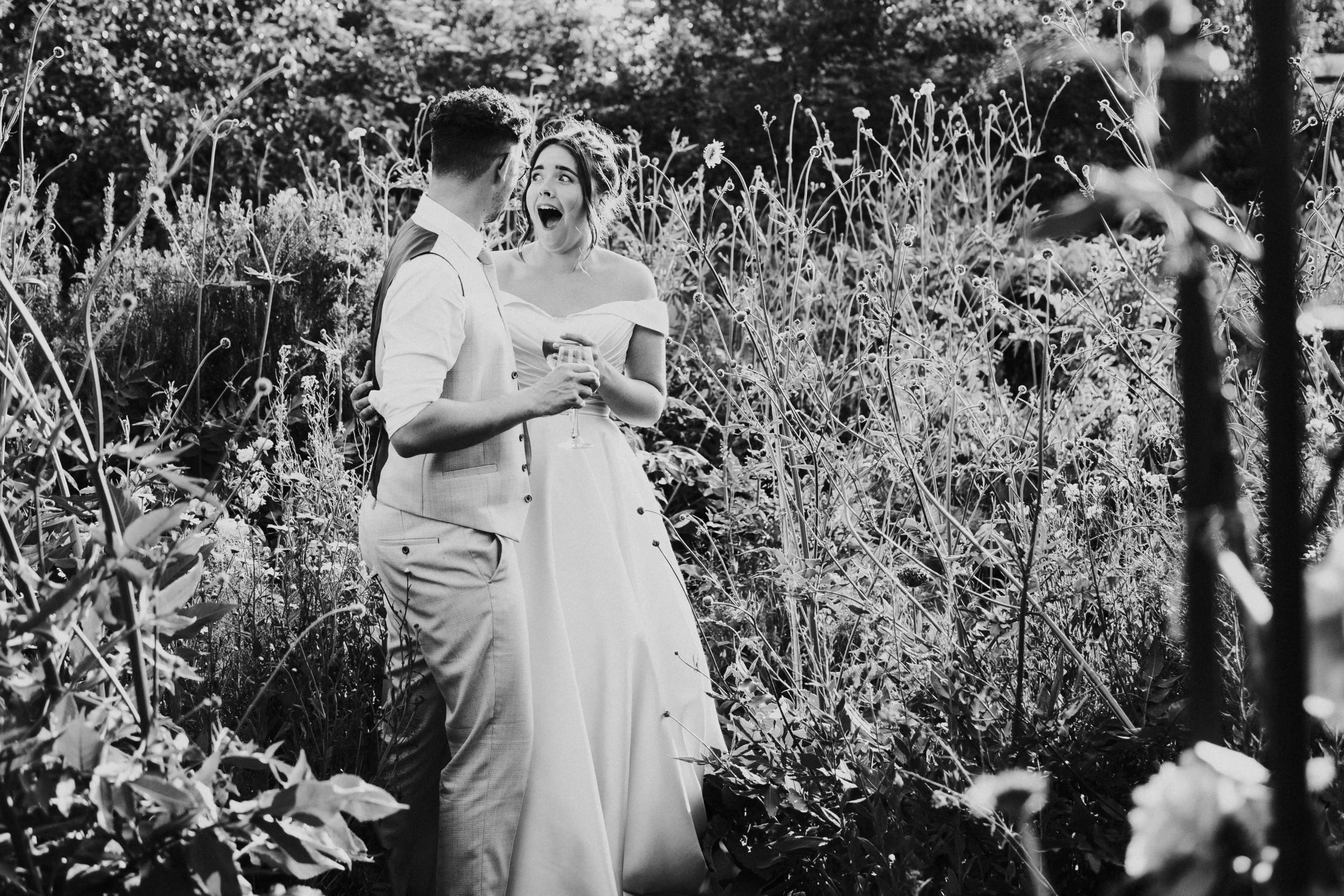 Wedding couple within a flower garden and the bride with a shock look at a Worton Kitchen Garden, Oxfordshire Wedding.