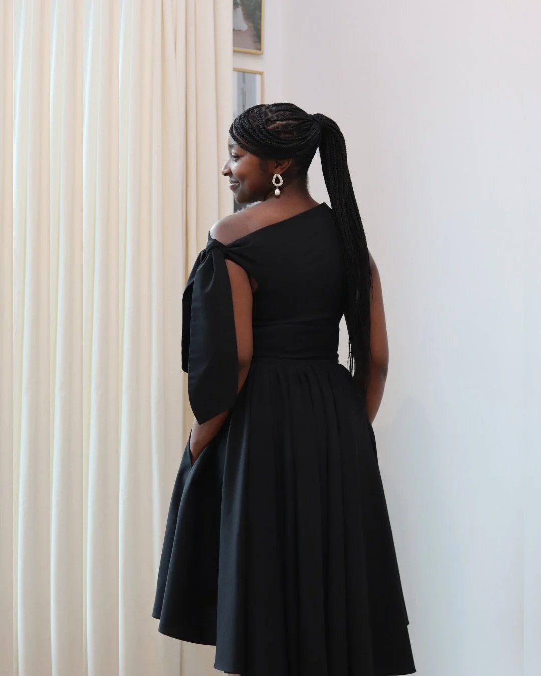 A little black dress, but with more drama. The Hibiscus Dress in black linen is sculpted with volume to flatter the waist, a cascading layered hem for fluid movement and an asymmetric bodice draped to frame the body. Timeless elegance made for evenin