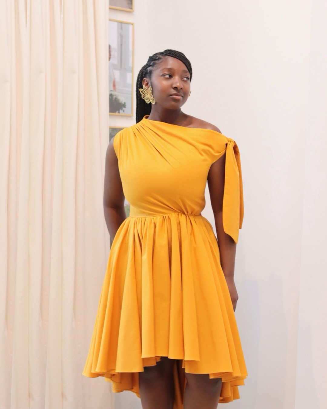 Radiate poise and presence, like a bloom in sunlight.

The Hibiscus Dress in marigold yellow linen reflects a golden warmth. Sculpted at the waist, a cascading layered hem moves effortlessly, and an asymmetric bodice drapes on the body with refined e