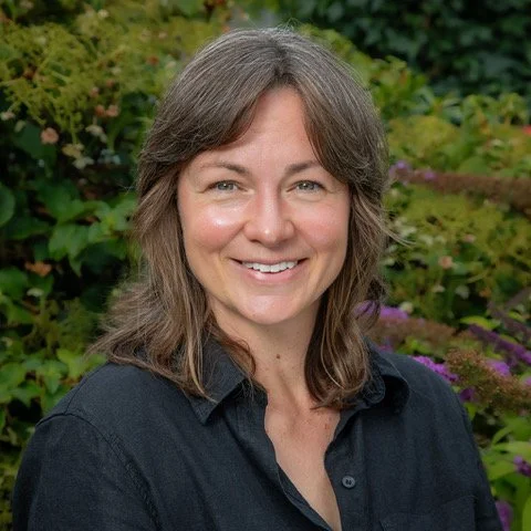 Laura Gormley photographed against a leafy background