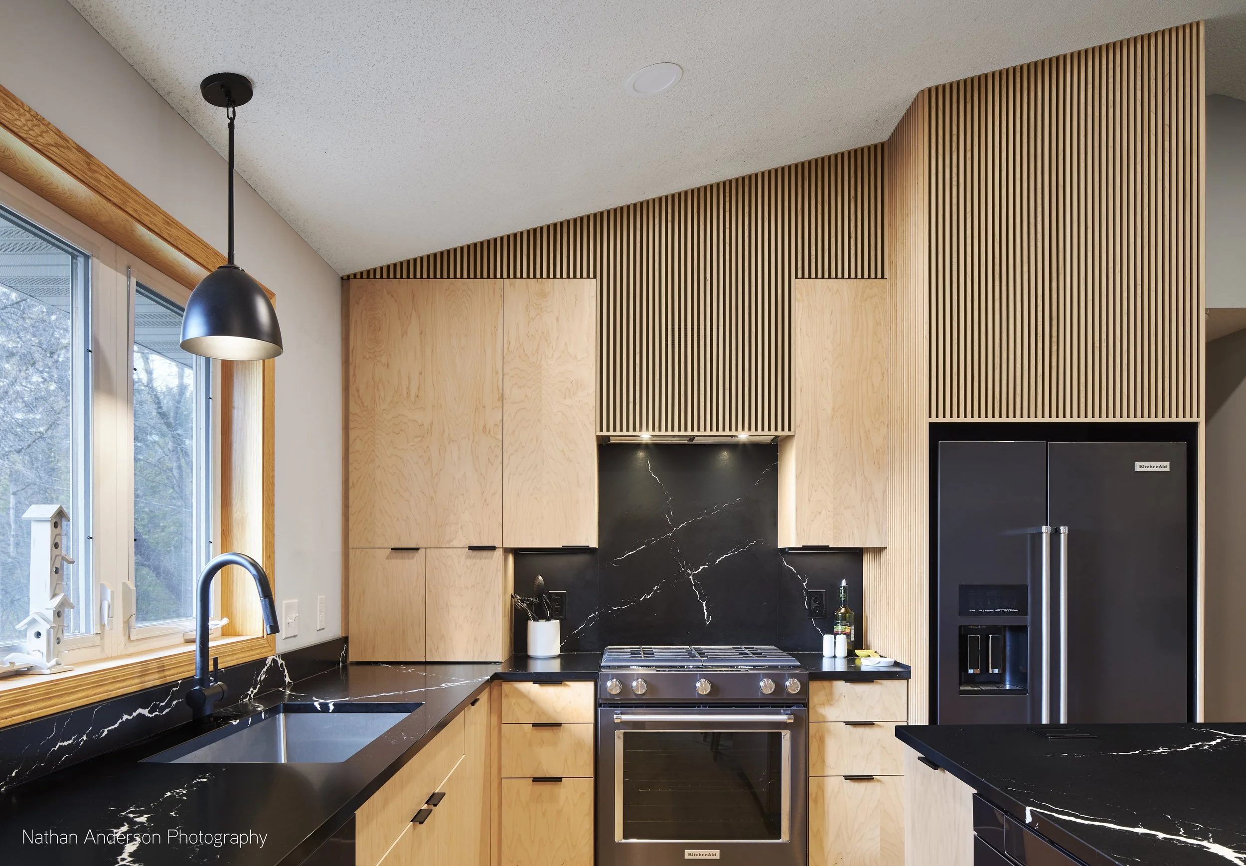 Maple cabinets and details throughout, including the slat wall. 