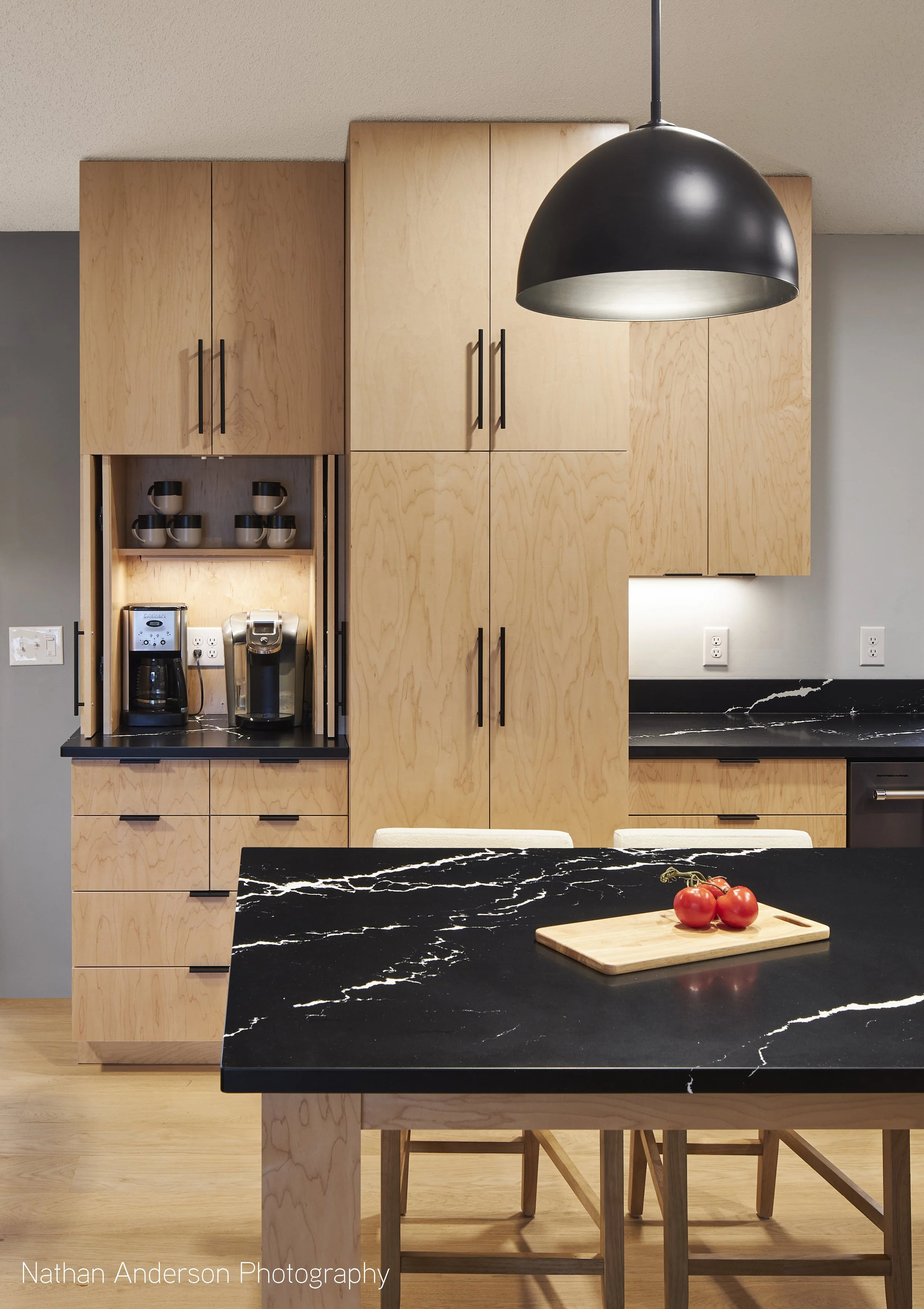 The coffee cabinet utilizes hinge-and-slide doors for a transforming display cabinet.