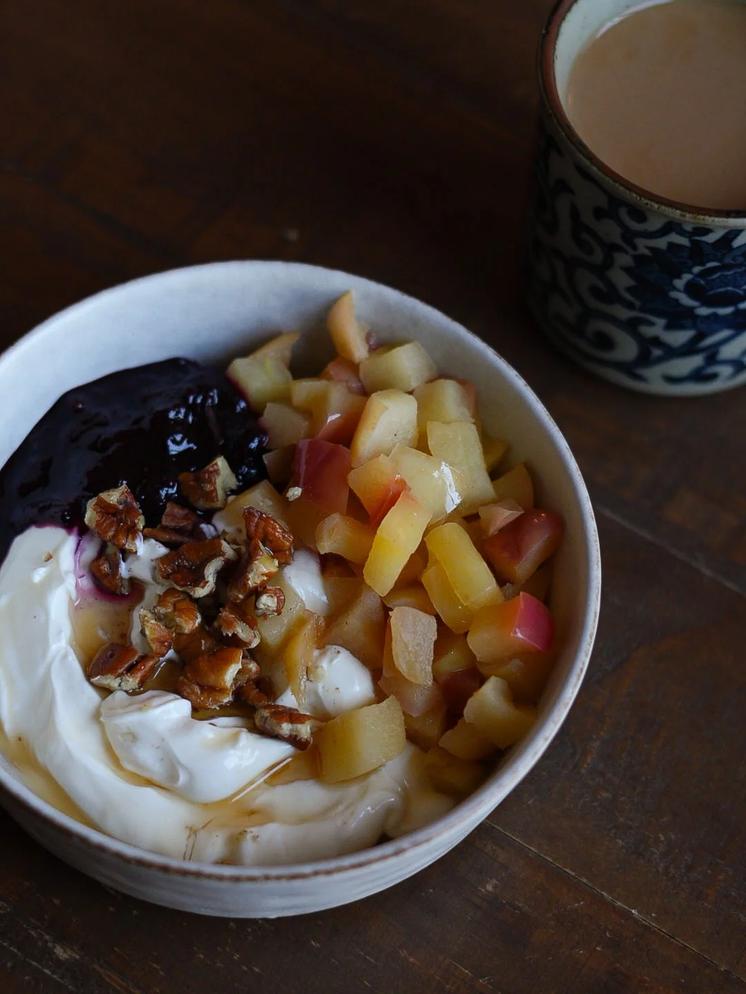 Yogurt with jam, nuts, and apples as a balanced snack with protein and carbohydrates