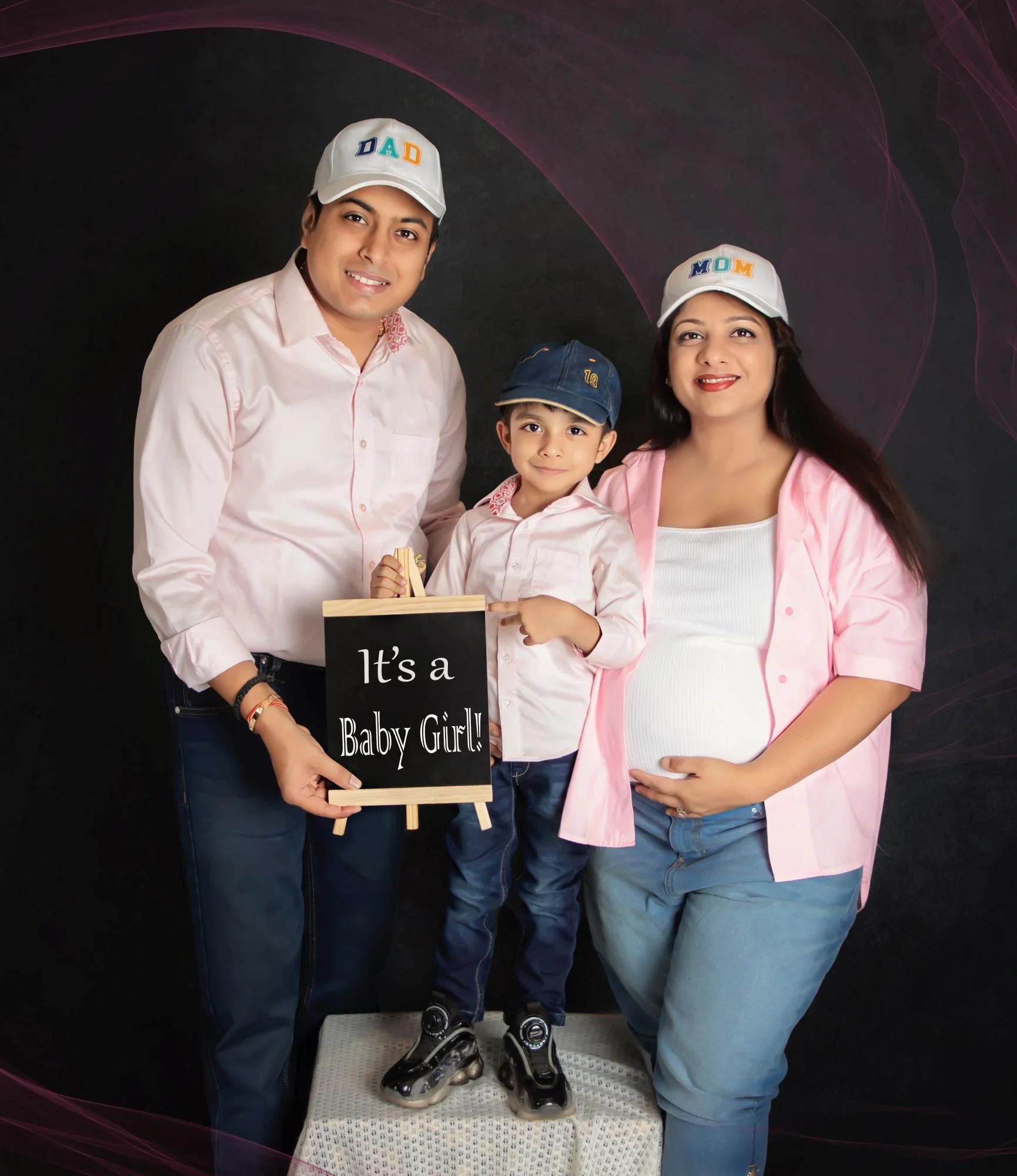 Family maternity photo of expecting couple with their elder child & baby bump