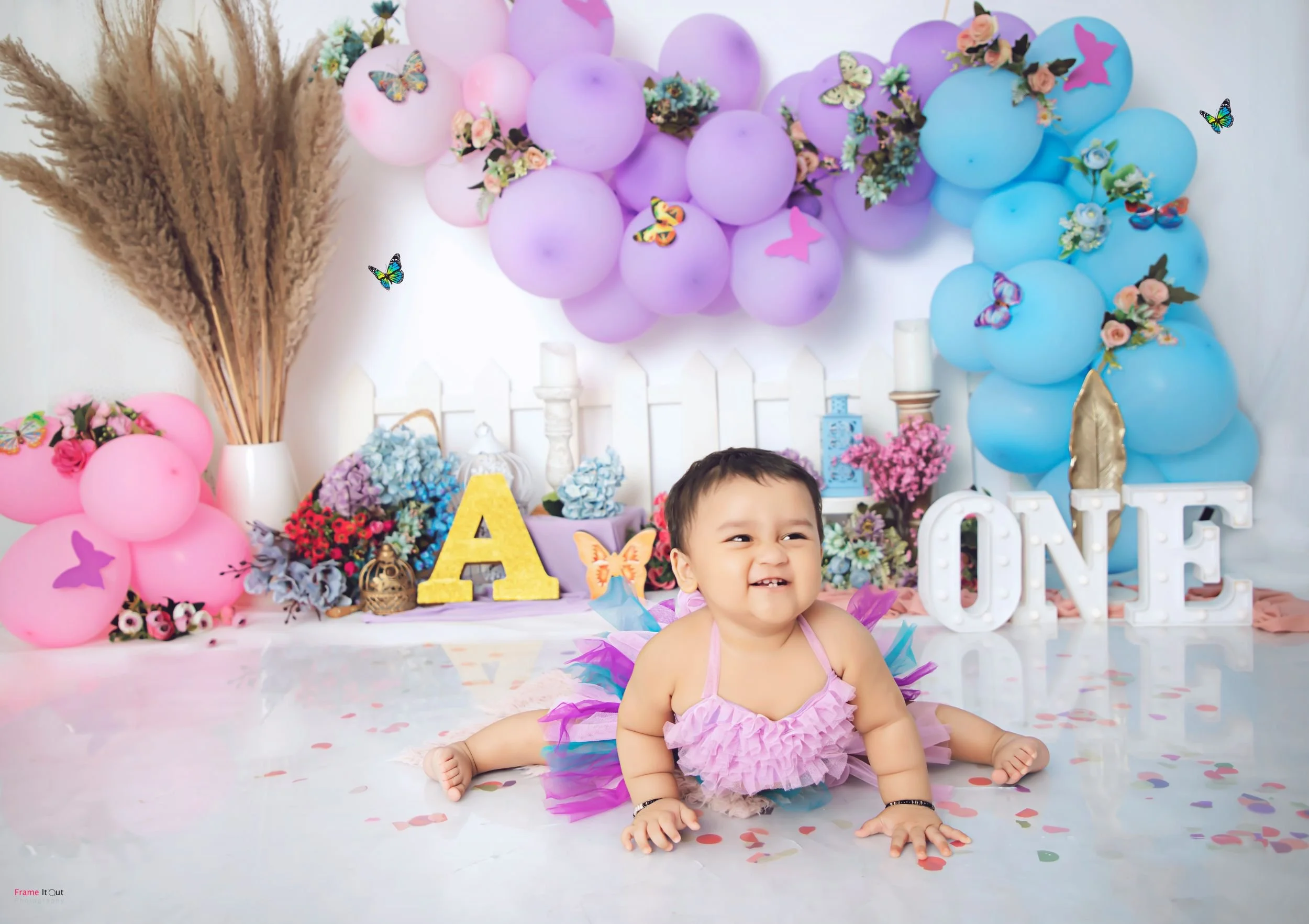 Creative sitter baby photography session at Frame It Out Photography studio in Faridabad, featuring premium themed setups for Delhi NCR families