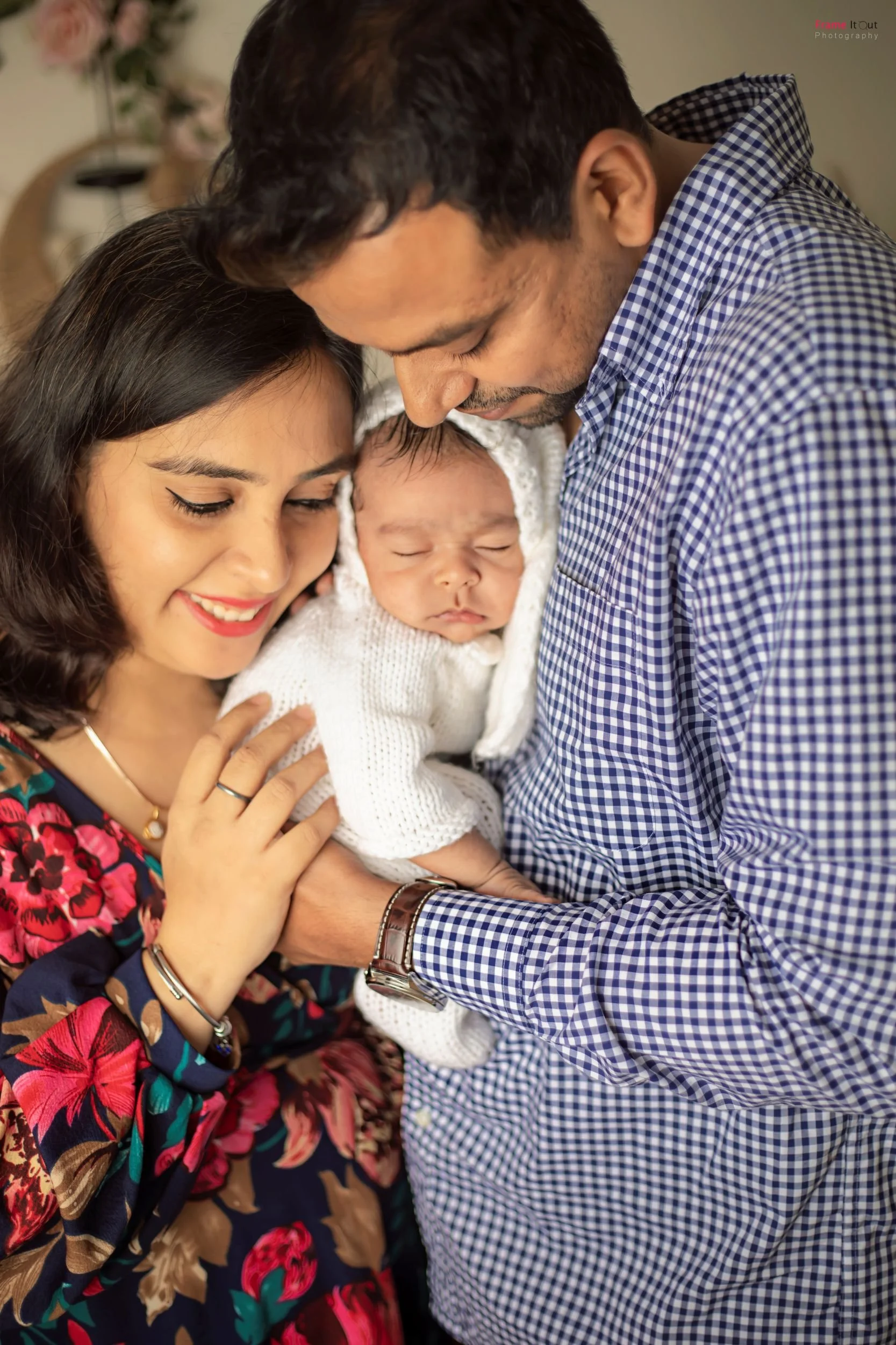 Close-up newborn baby with parents – luxury newborn photographer