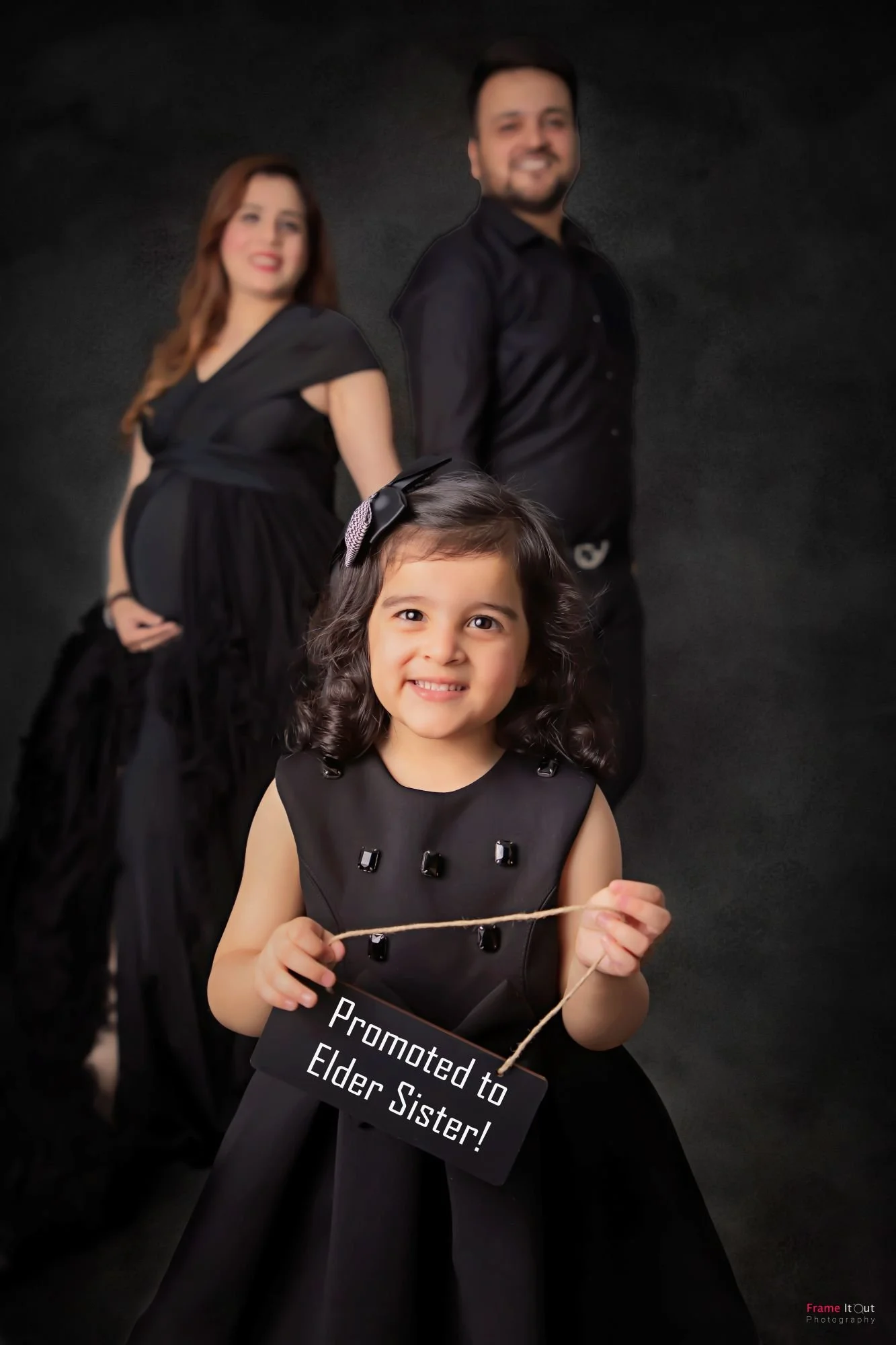 Maternity family moment with mom, dad and older child laughing together