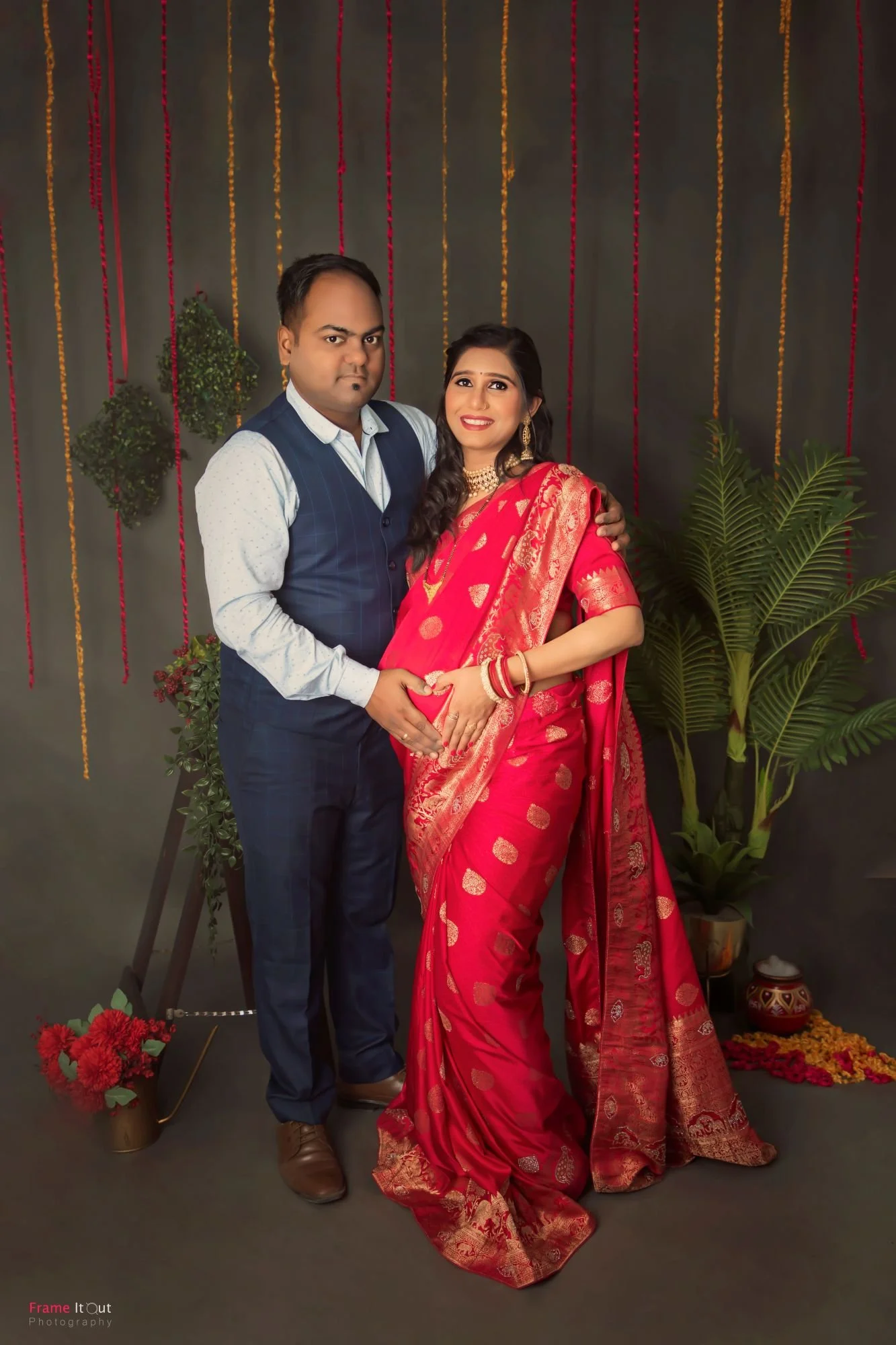 Classic couple maternity pose with hands forming a heart on the belly