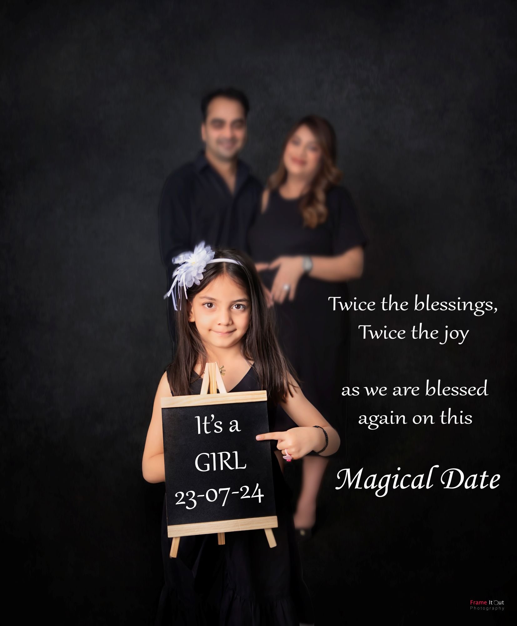 Maternity family picture with parents and older child holding sign or prop